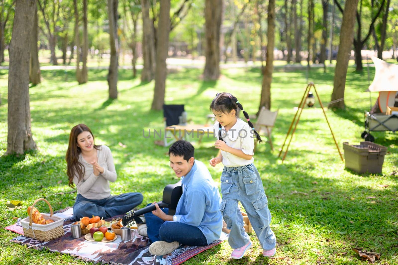 Family spending quality time together at a sunny campsite.