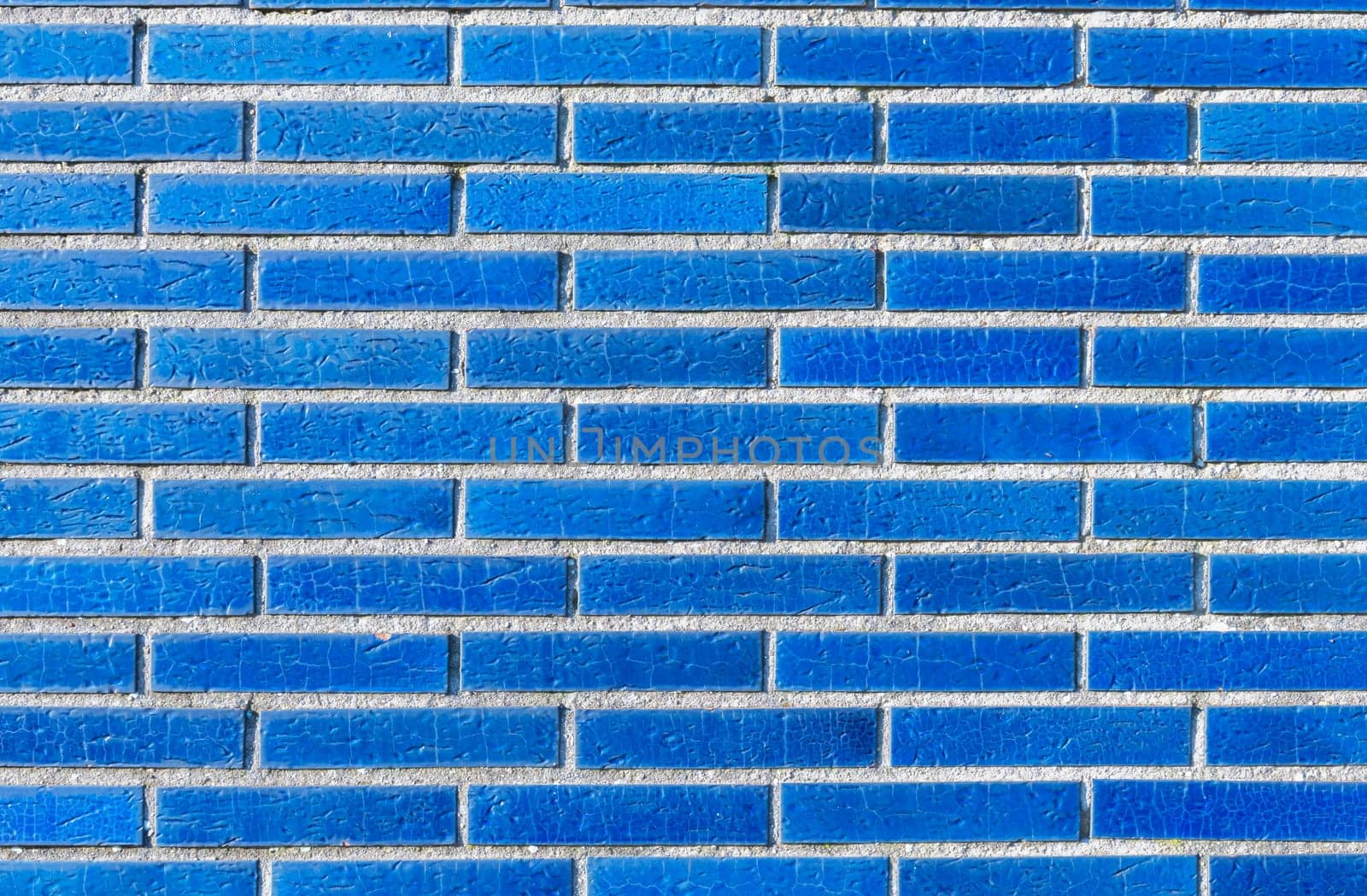 Close up of unique blue brick wall with luxurious ceramic effect, neatly laid bricks create pattern and texture, modern house facade design concept in Europe,