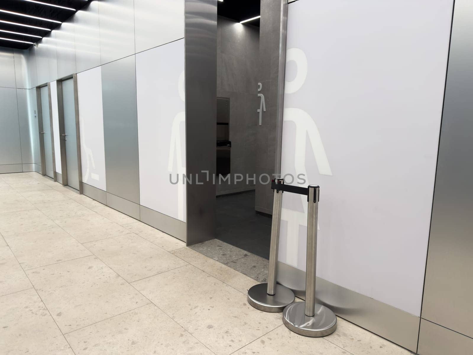 Modern public restroom entrance with clear male and female symbols and barrier free access offers hygienic toilet. Solutions for families and people with disabilities in urban spaces