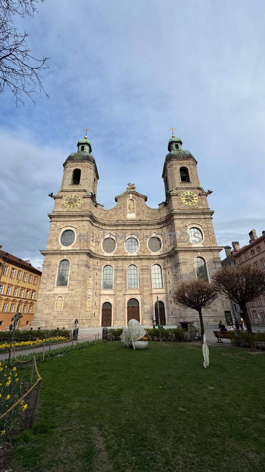 Innsbruck, Austria - March 28, 2025: Historic Jesuit Church with twin towers and stunning architecture located in the city center of Innsbruck, representing cultural heritage