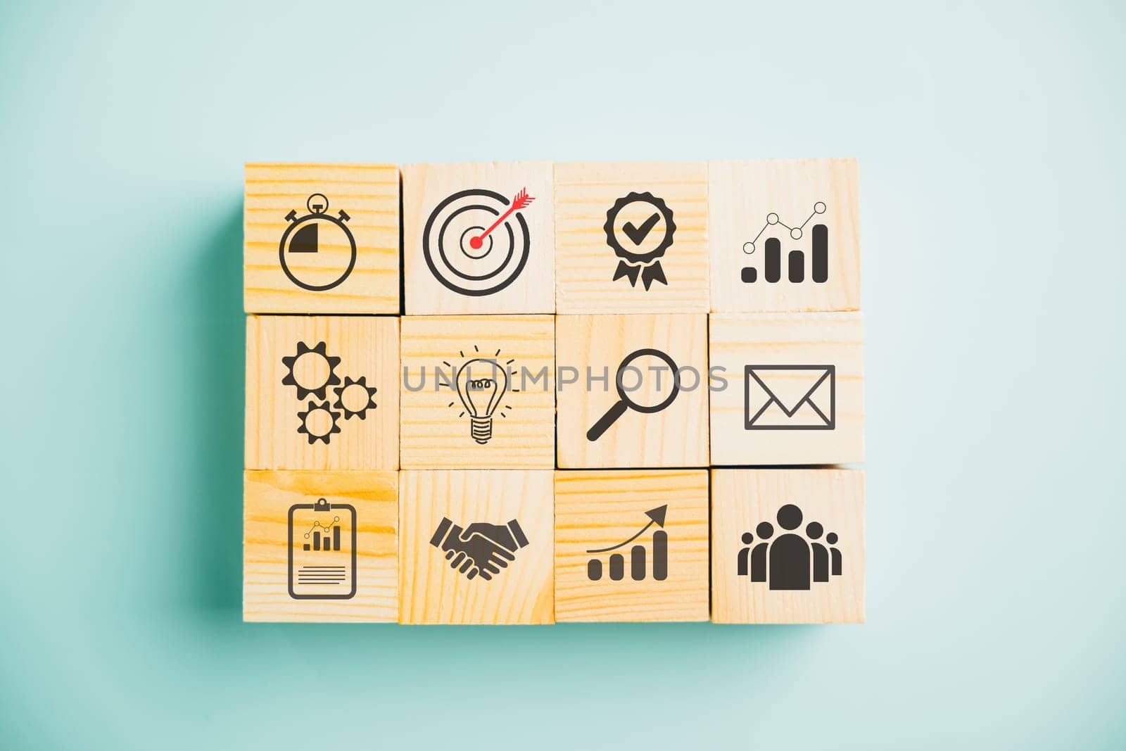 Business target concept with a wooden cube block step. Action Plan and Goal icons symbolize success. Project management and company strategy on a blue background.