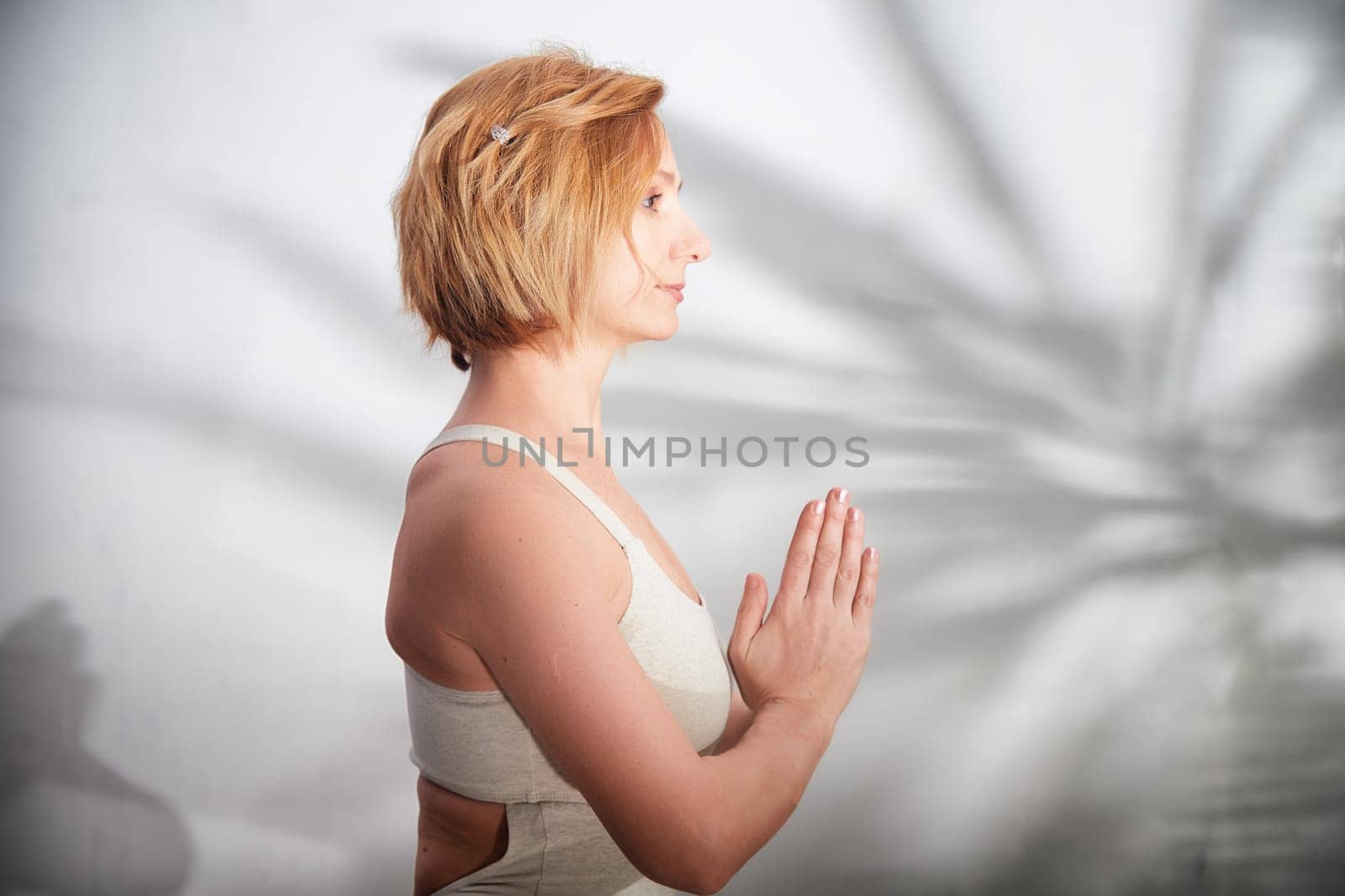 A person is engaged in yoga, focusing on mindfulness and balance in a serene indoor setting.