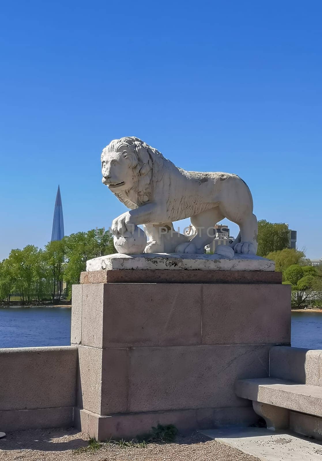 Saint Petersburg, Russia - 05.18.24. A lion statue stands on a pedestal in the park of culture and recreation on Elagin Island. Shot on a smartphone.