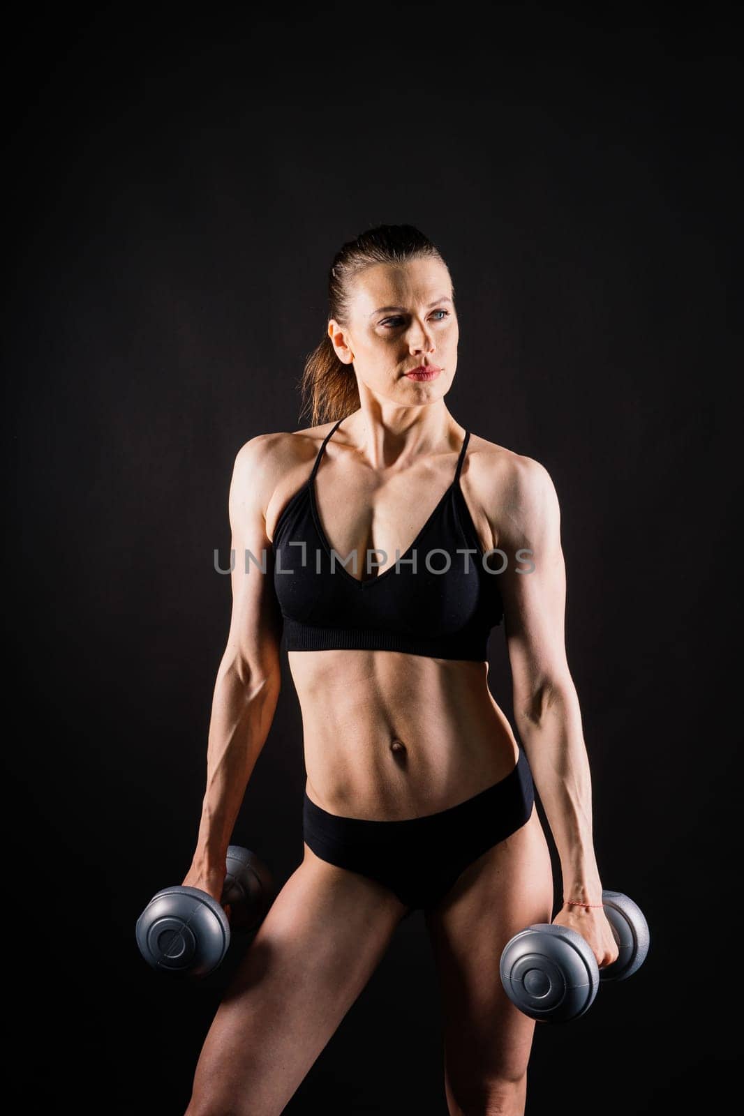 Happy woman do exercise with a dumbbell. Smiling female, fitness workout. Healthy lifestyle concept.