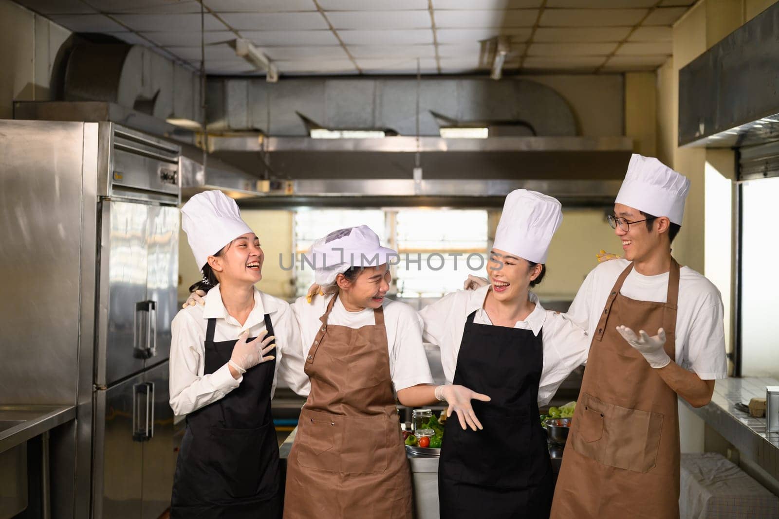 Cooking school classmates sharing a joyful conversation after class.