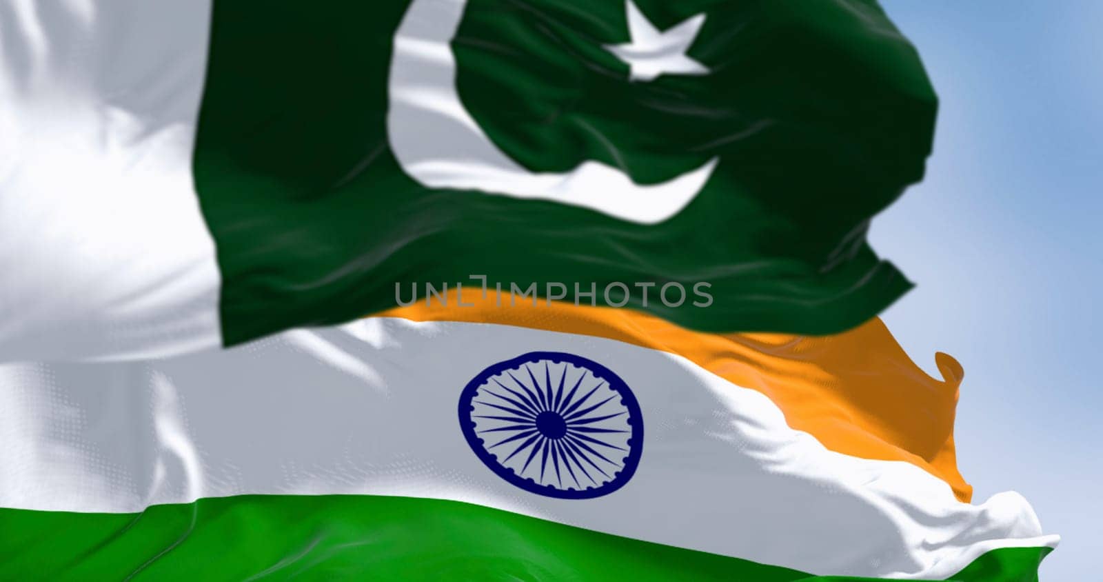 Pakistan and India national flags waving on a clear day. 3d illustration render. Selective focus. Rippling fabric