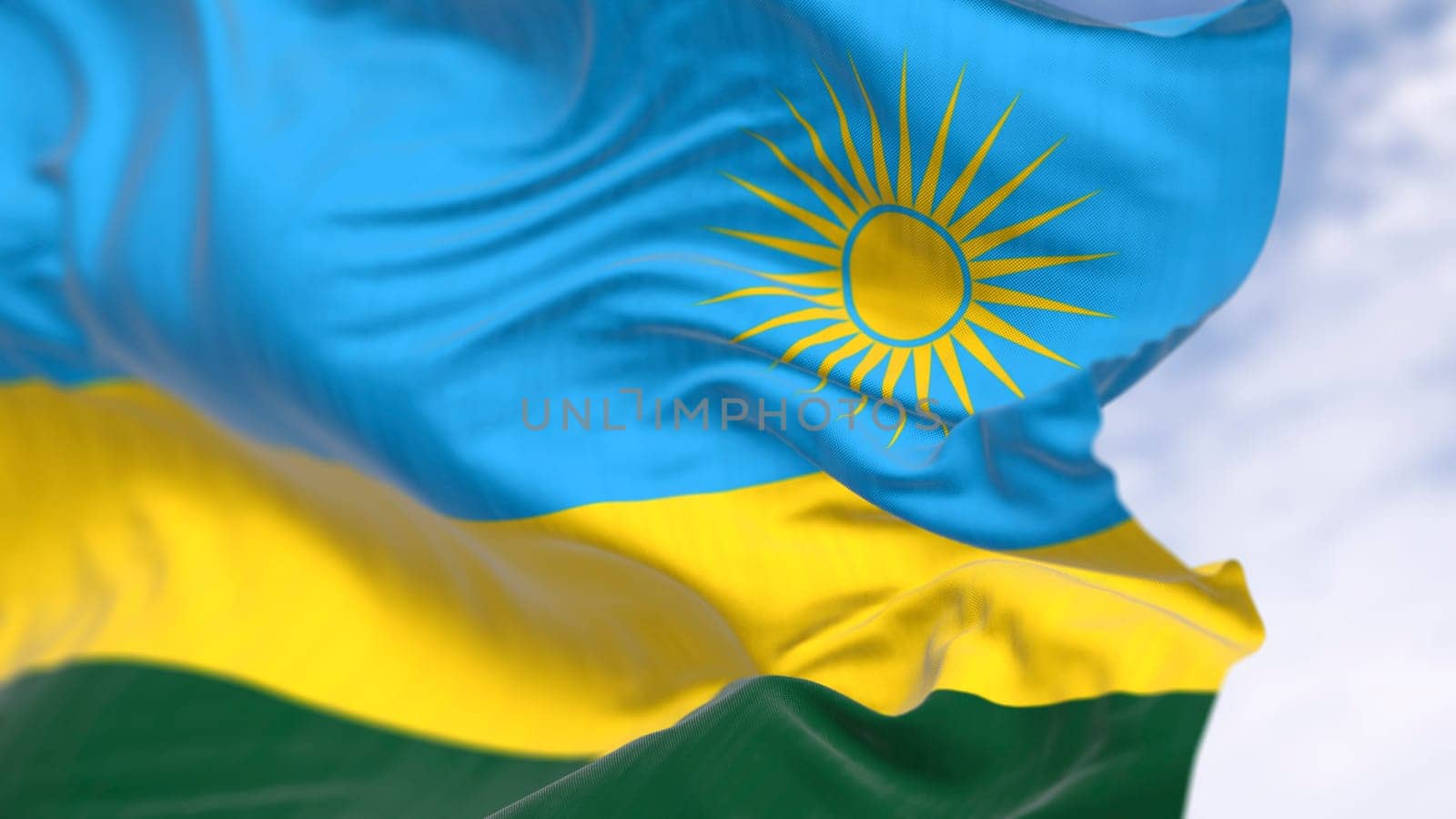 Close-up of Rwanda national flag waving on a clear day. Three horizontal bands: blue, yellow, green with 24 rays yellow sun. 3d illustration render. Selective focus