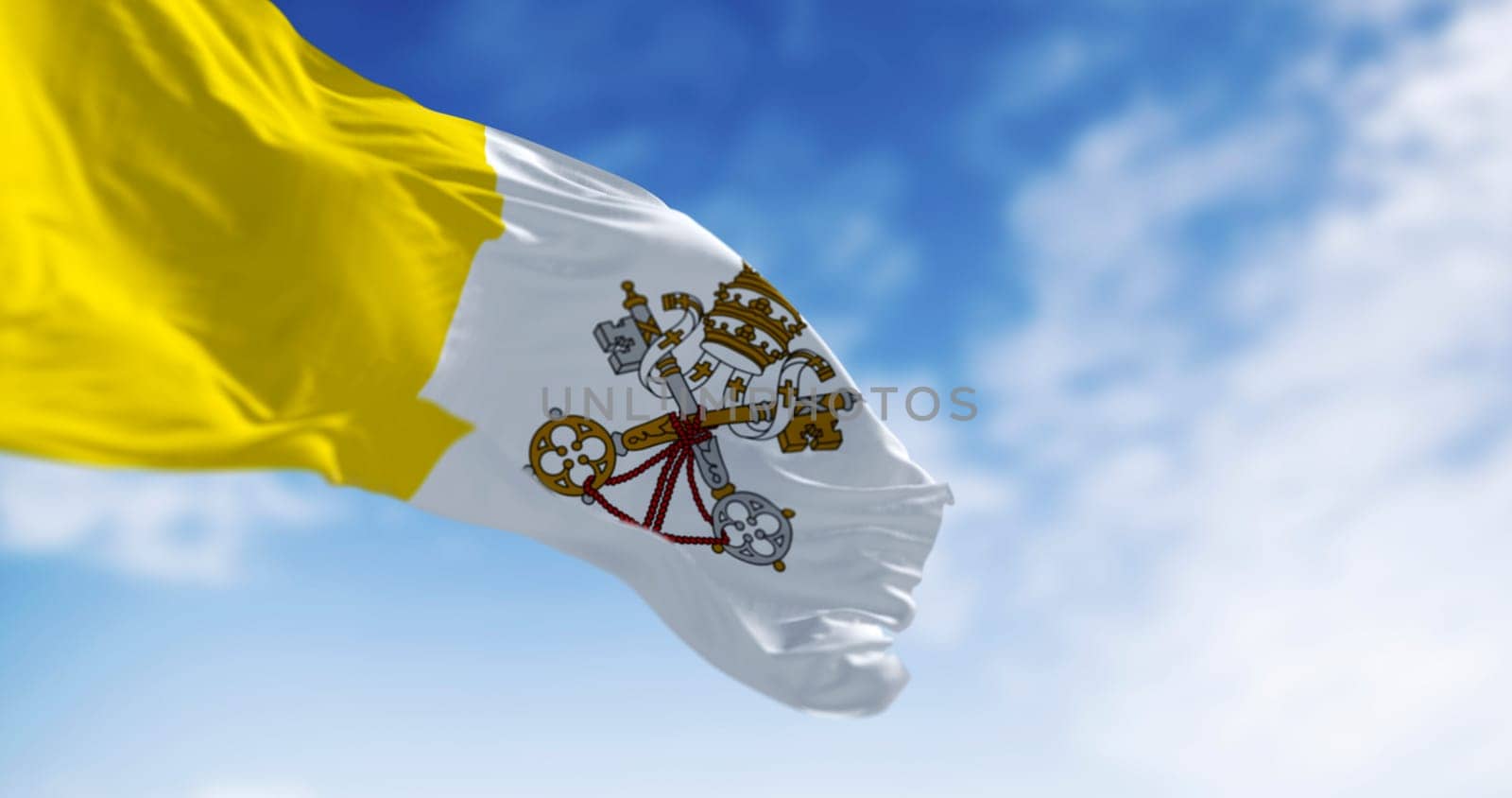 Flag of Vatican City waving in the wind on a clear day. Vertical bicolour of gold and white with the coat of arms centred on the white portion. 3d illustration render. Fluttering fabric