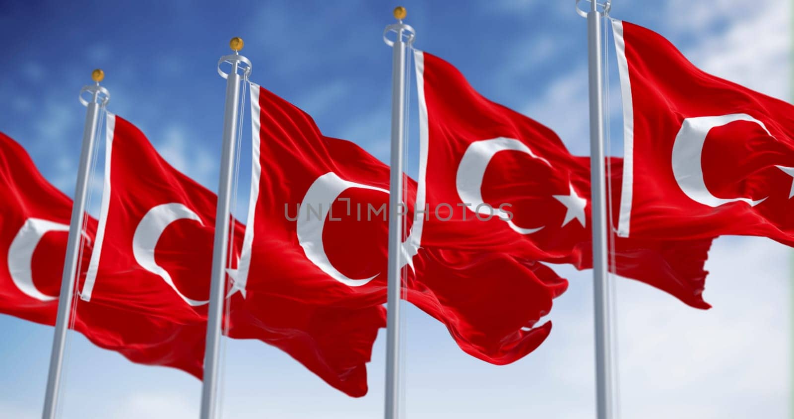 Turkish national flags waving in the wind on a clear day. Red flag with white crescent and a star. 3D illustration render. Fluttering fabric. Selective focus