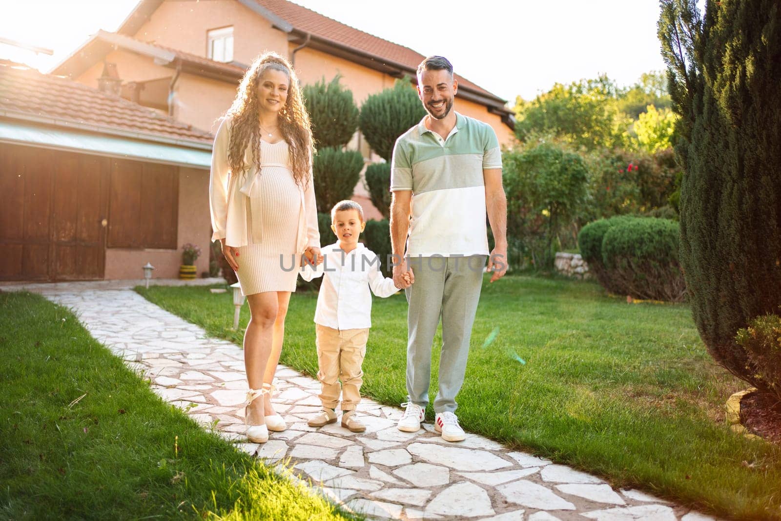 Joyful family strolls together on a sunny afternoon.