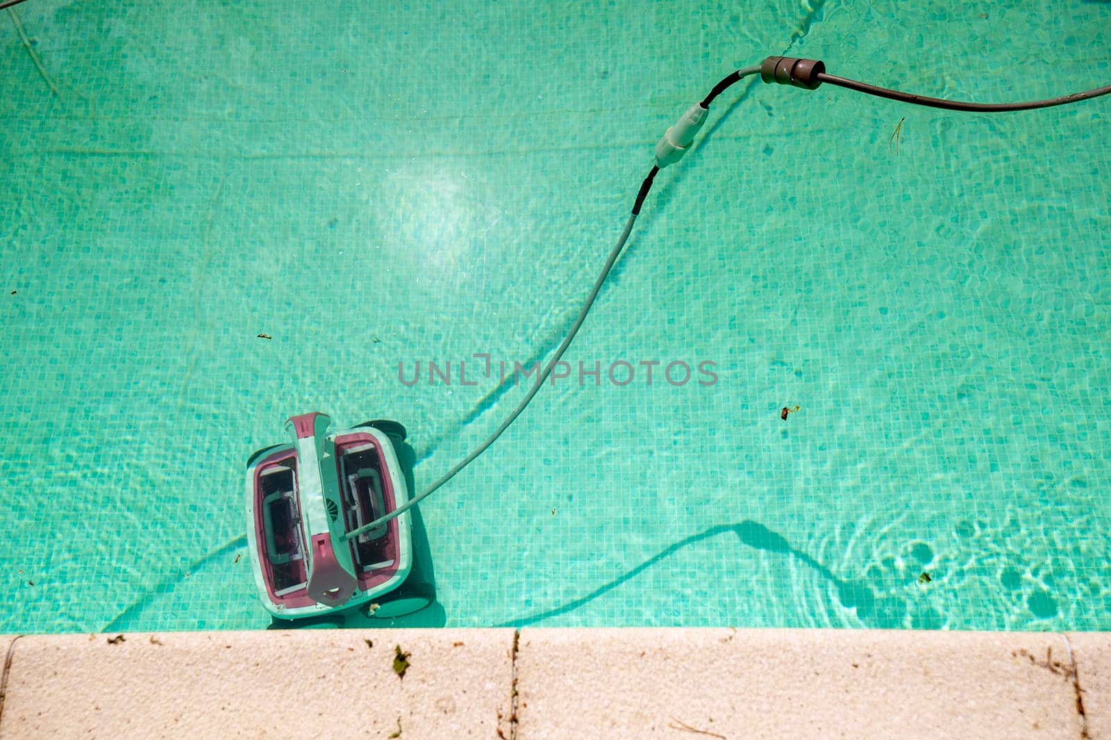 pool cleaning. Underwater pool vacuum cleaner. Robotic cleaning of the pool floor. robot Pool maintenance with automatic robot. Cleaning the bottom and walls with a submersible robot. .