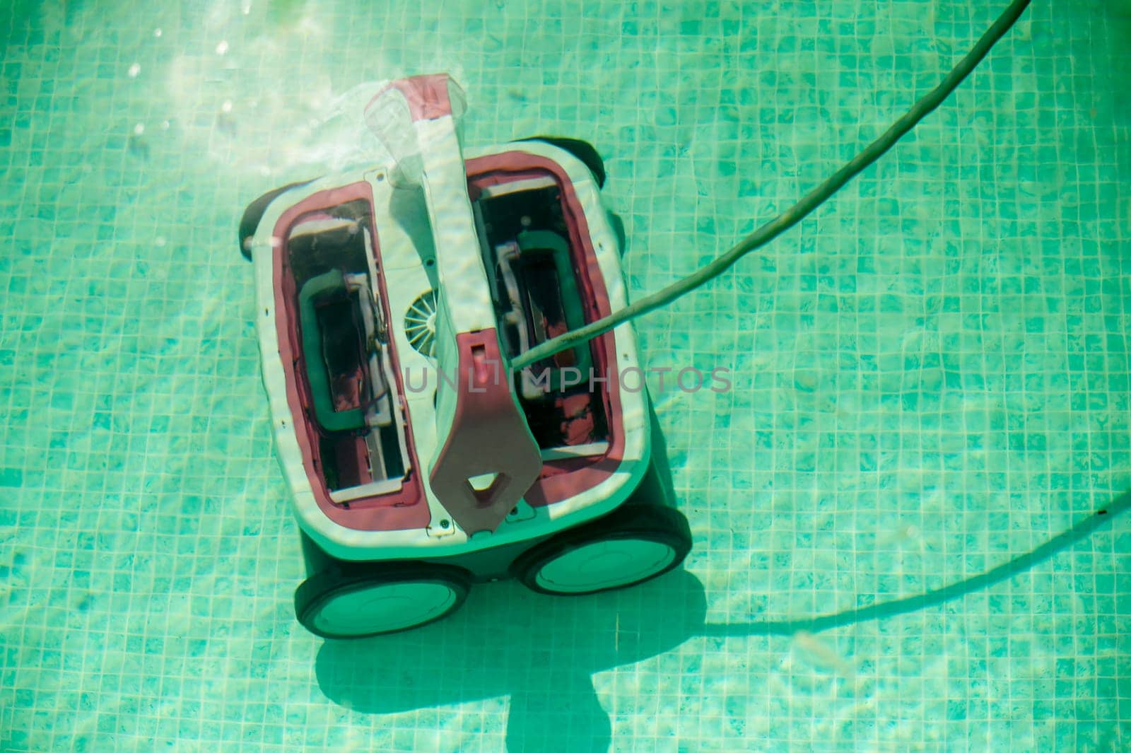 pool cleaning. Underwater pool vacuum cleaner. Robotic cleaning of the pool floor. robot Pool maintenance with automatic robot. Cleaning the bottom and walls with a submersible robot. . High quality photo