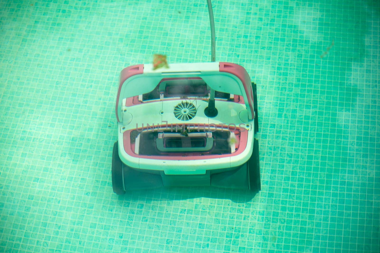 Underwater pool vacuum cleaner. Robotic cleaning of the pool floor. robot Pool maintenance with automatic robot. Cleaning the bottom and walls with a submersible robot. Smart home technologies