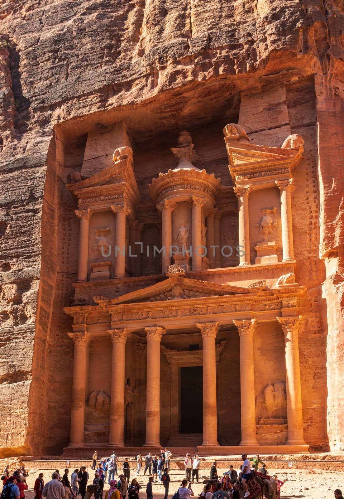 Petra, Jordan - 10 November 2024: Tourists at the carved facade of the Treasury building or Al-Khazneh in the ancient city of Petra