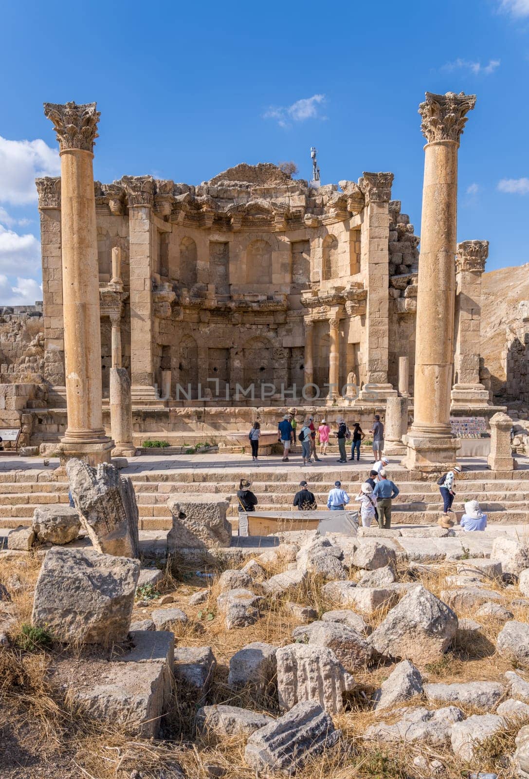 Jerash, Jordan - 11 November 2024: Tourists view the Nymphaeum or public fountain on Cardo Maximus in Jerash