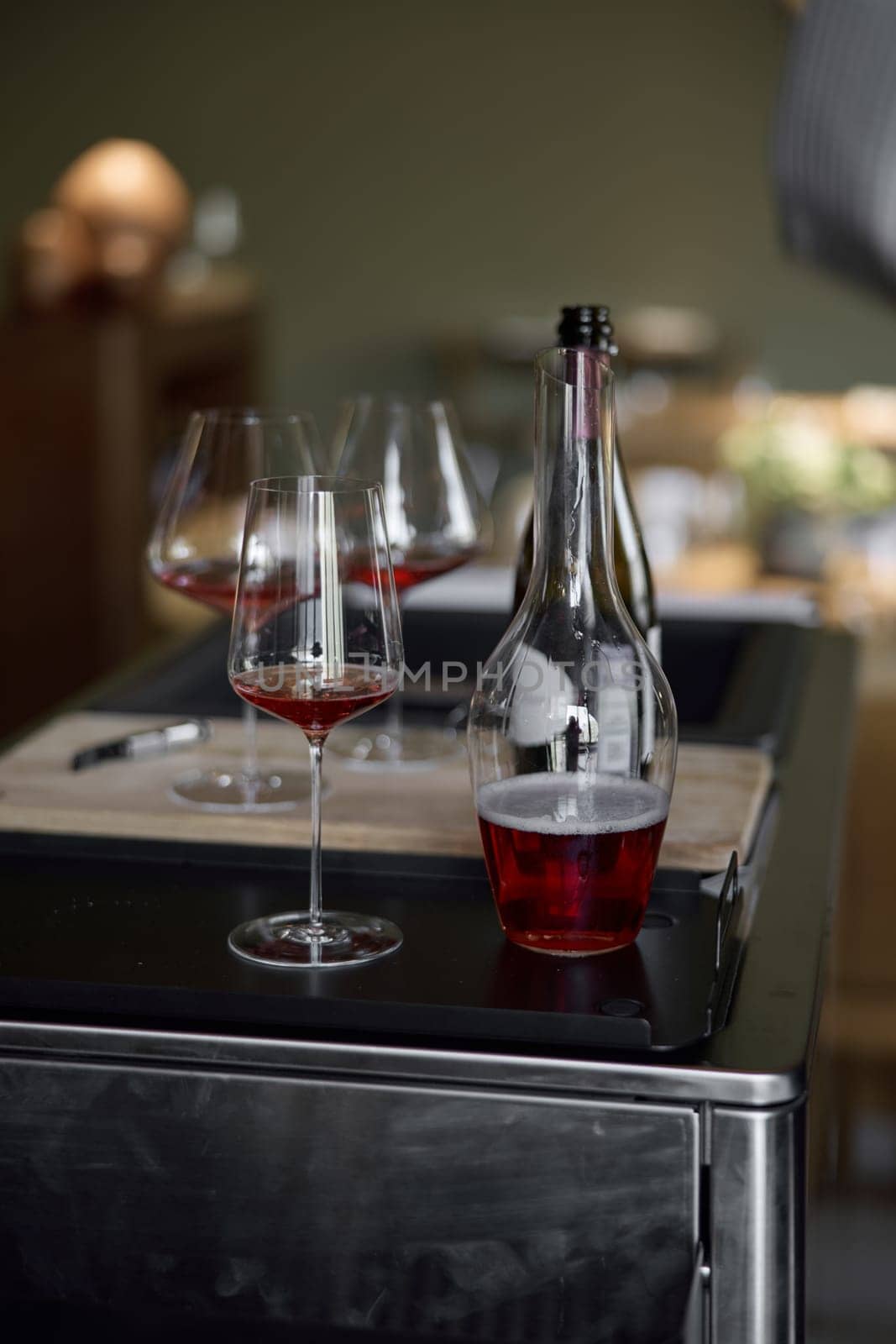 Decanter for sparkling wine on the table, Champagne tasting, Wine glasses and bottle, reflections, rose wine. High quality photo