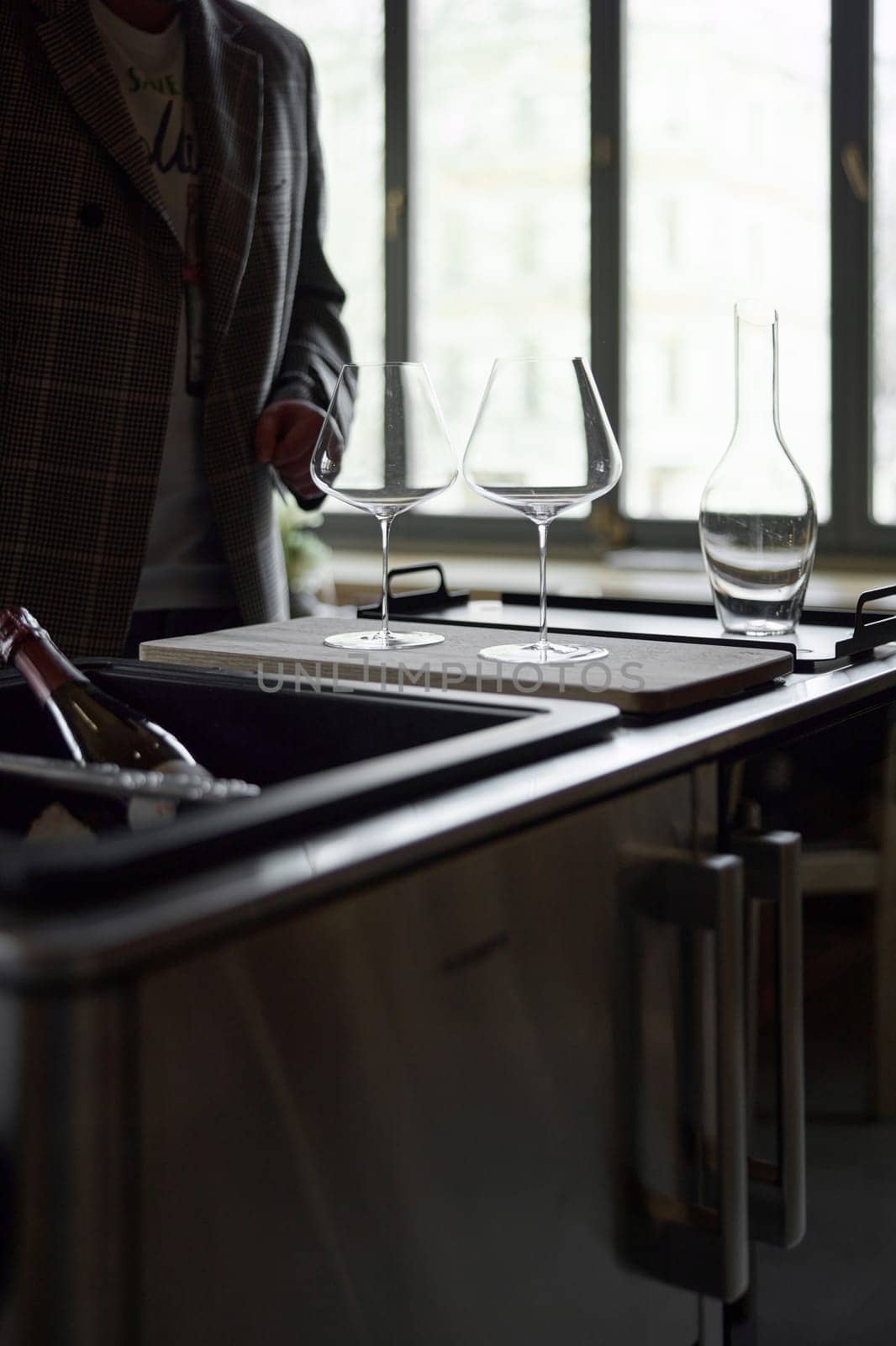 Clean wine glasses and decanter are on the table of a special wine cabinet, stylish table setting, ice, light from window, decoder and degasser. High quality photo
