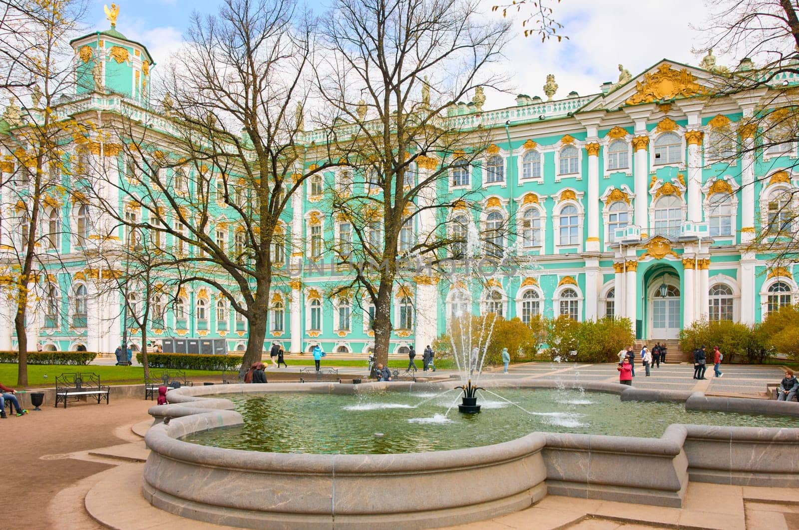 Russia,St. Petersburg, 10 May 2025: the incredibly picturesque facade of the Winter Palace through the branches of trees on a clear spring day, the heritage, the most famous landmark, the museum. High quality photo