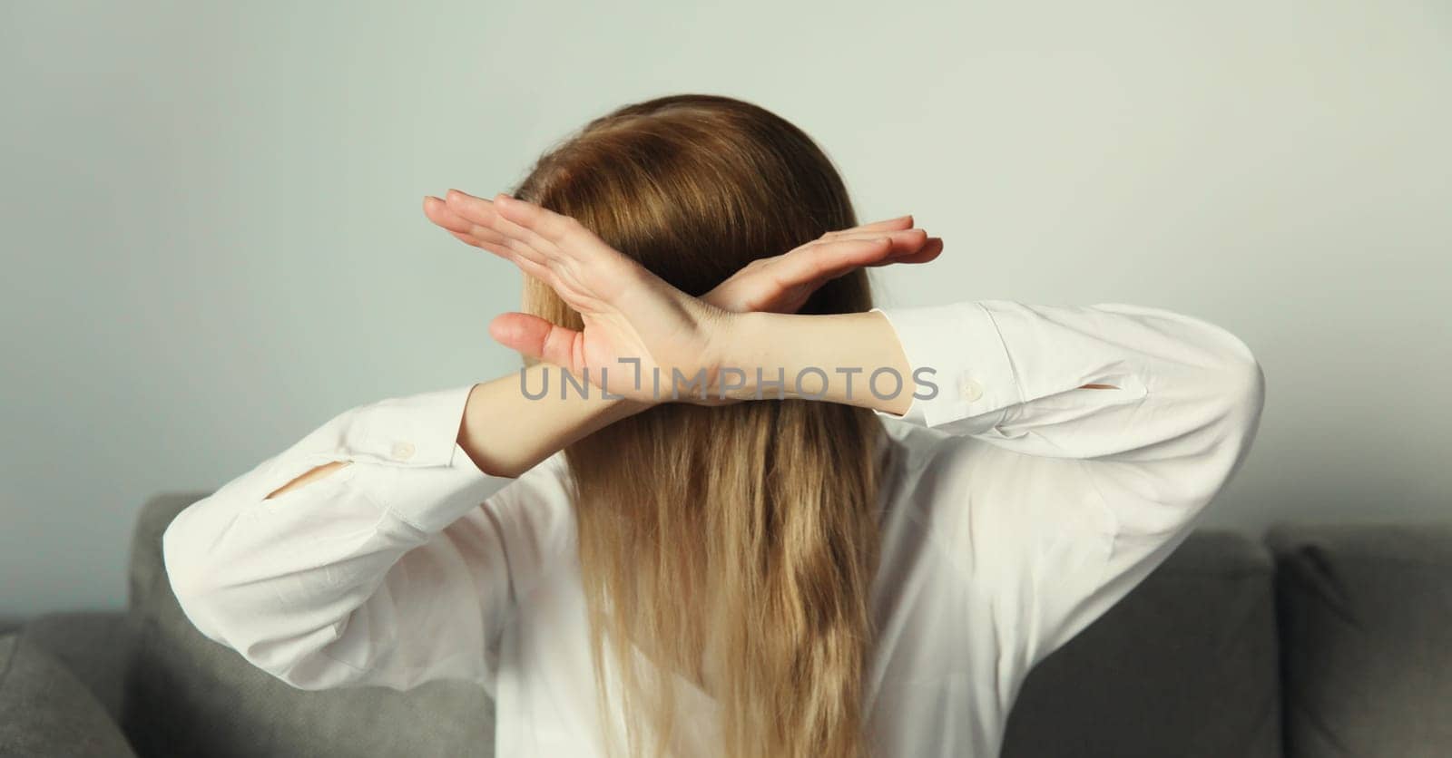 Close-up upset young woman shows stop, no or enough sign with palm of hand, refusal gesture, domestic violence
