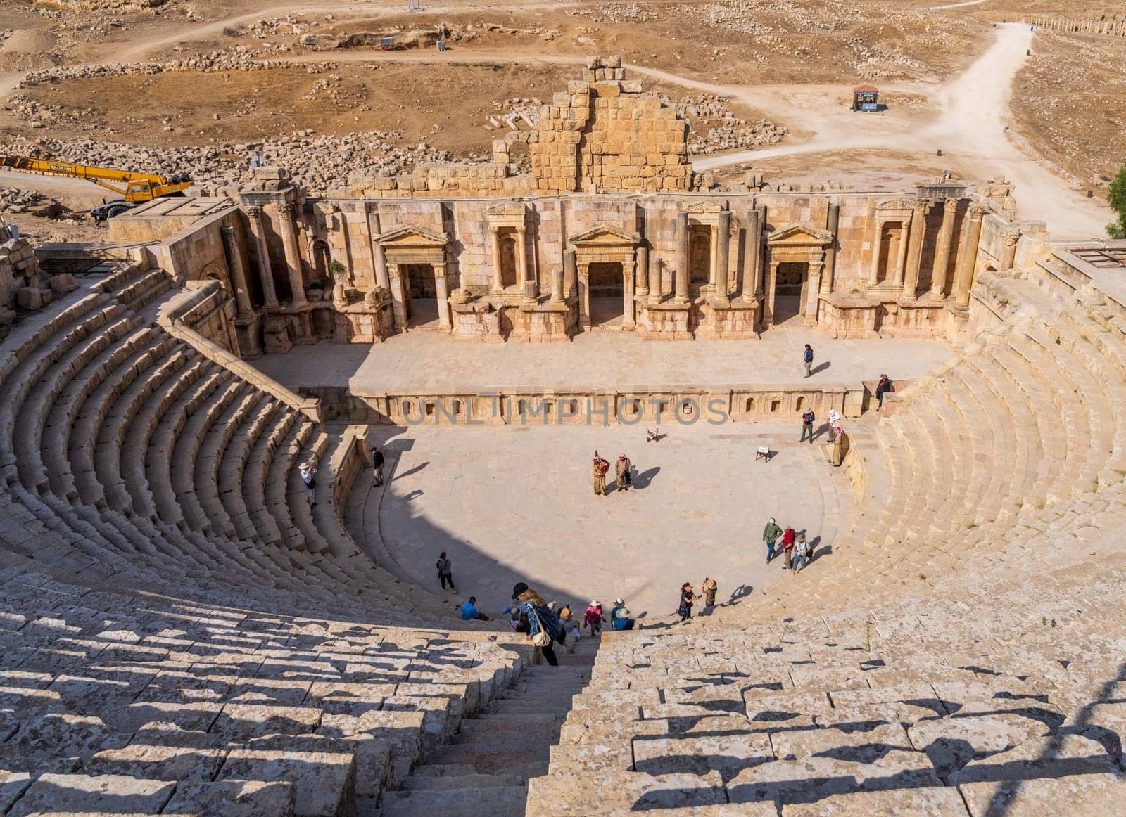 Jerash, Jordan - 11 November 2024: Tourists on the seats above the stage of South Theater in Jerash, a Greco-Roman well preserved city in Jordan