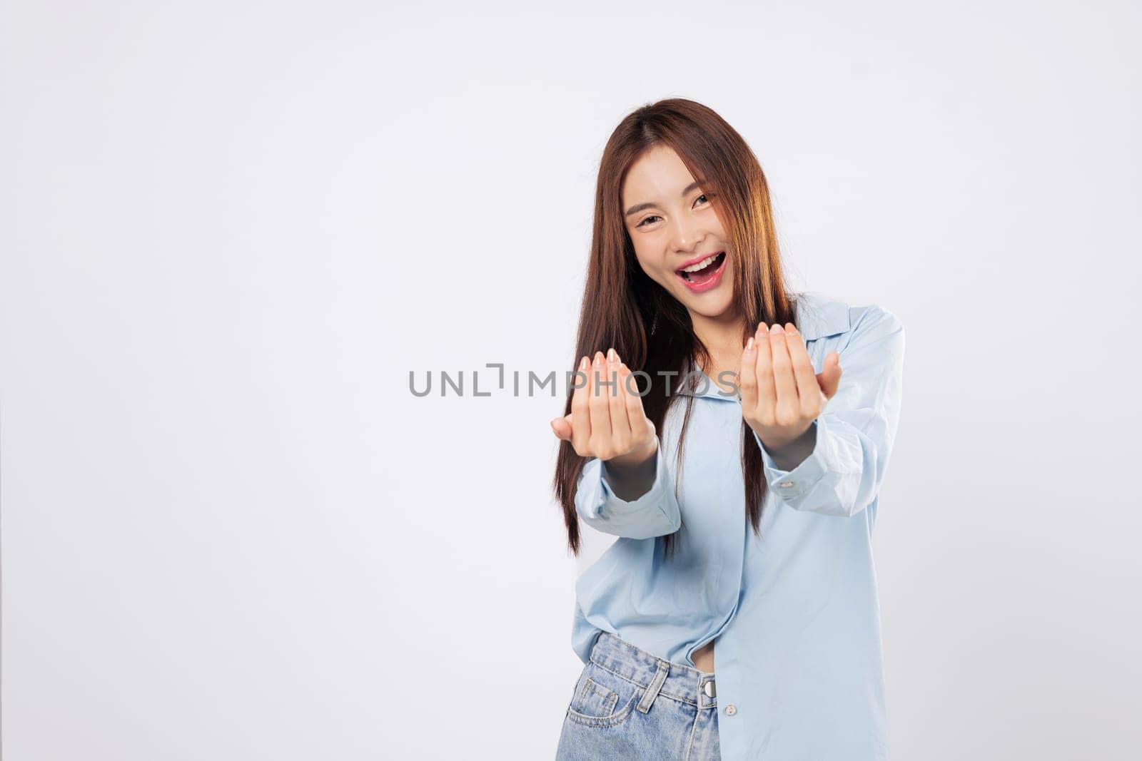 Come here motion made by inviting woman, second woman extends her palm with friendly eyes and soft gesture, both shown isolated on a white background.