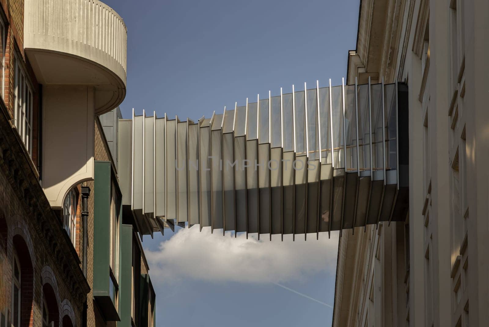 London, UK - May 13, 2025 - The futuristic modern of Twisted sky bridge connecting Royal opera house to Royal ballet school in Covent garden, Exterior architectural design of Bridge of Aspiration in London, Stunning view of Passageway between buildings, use it as your Wallpaper, Poster and Copy space, Selective focus.