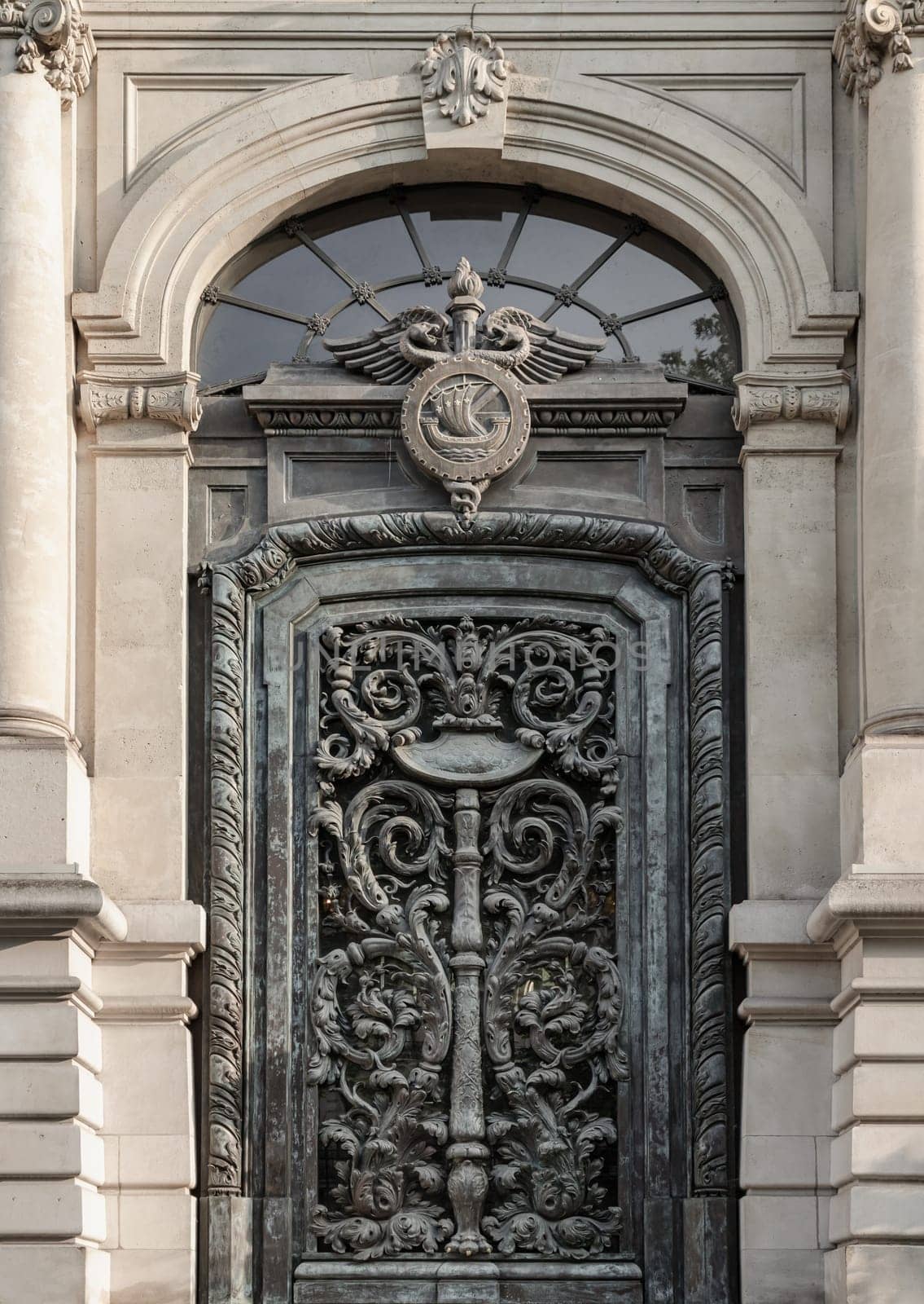 France, Paris - May 03, 2025 - Magnificent entrance facade door of The Paris Chamber of Commerce and Industry building (Chambre de commerce de Paris) is a French chamber of commerce that supports businesses in Paris and the ile-de-France region. It located at Friedland avenu, use it as your Wallpaper, Poster and Space for text, Selective focus.