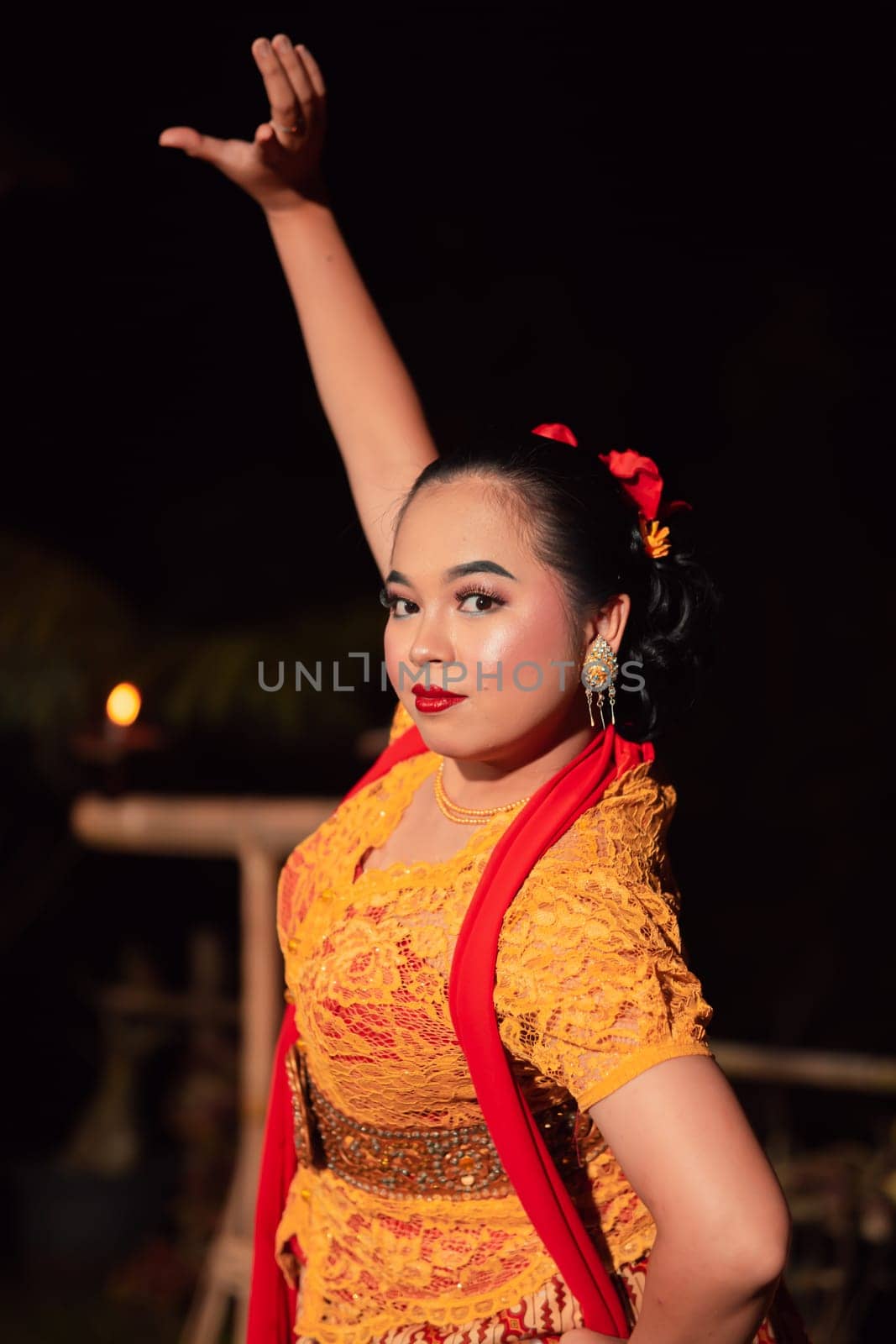 Indonesian women wearing traditional dance costumes called kebaya and pose with dancing moves in the night after the performance