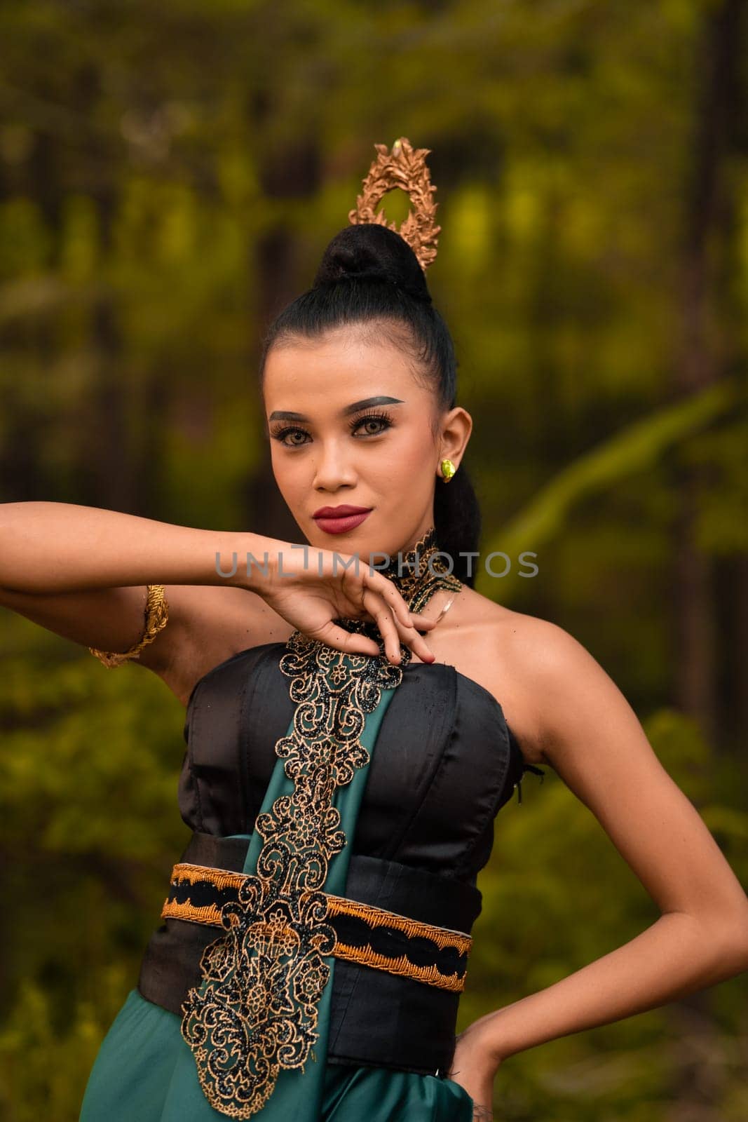The fierce face of an Indonesian woman wearing makeup on her face and a black costume after a dance performance at the festival