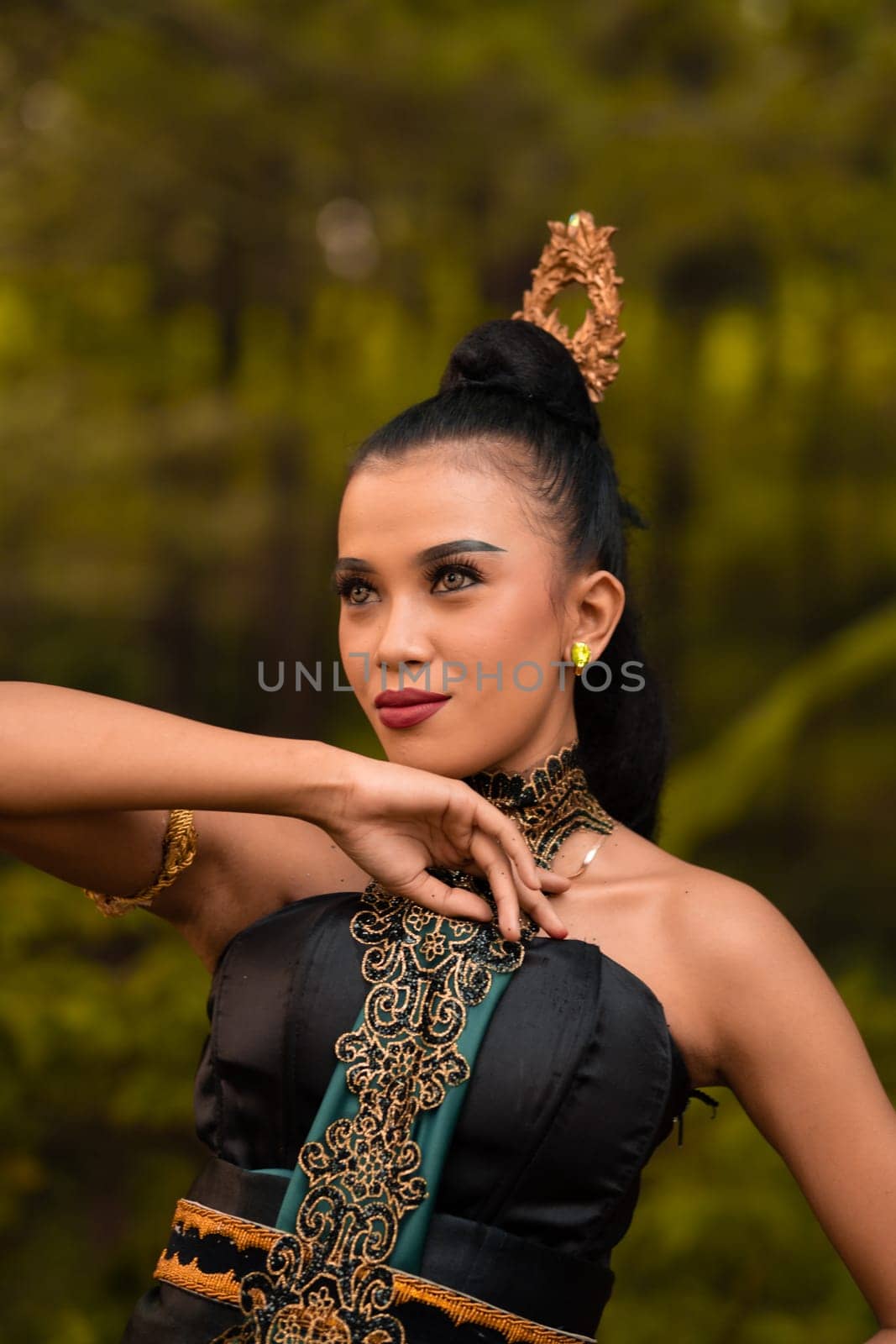 The fierce face of an Indonesian woman wearing makeup on her face and a black costume after a dance performance at the festival