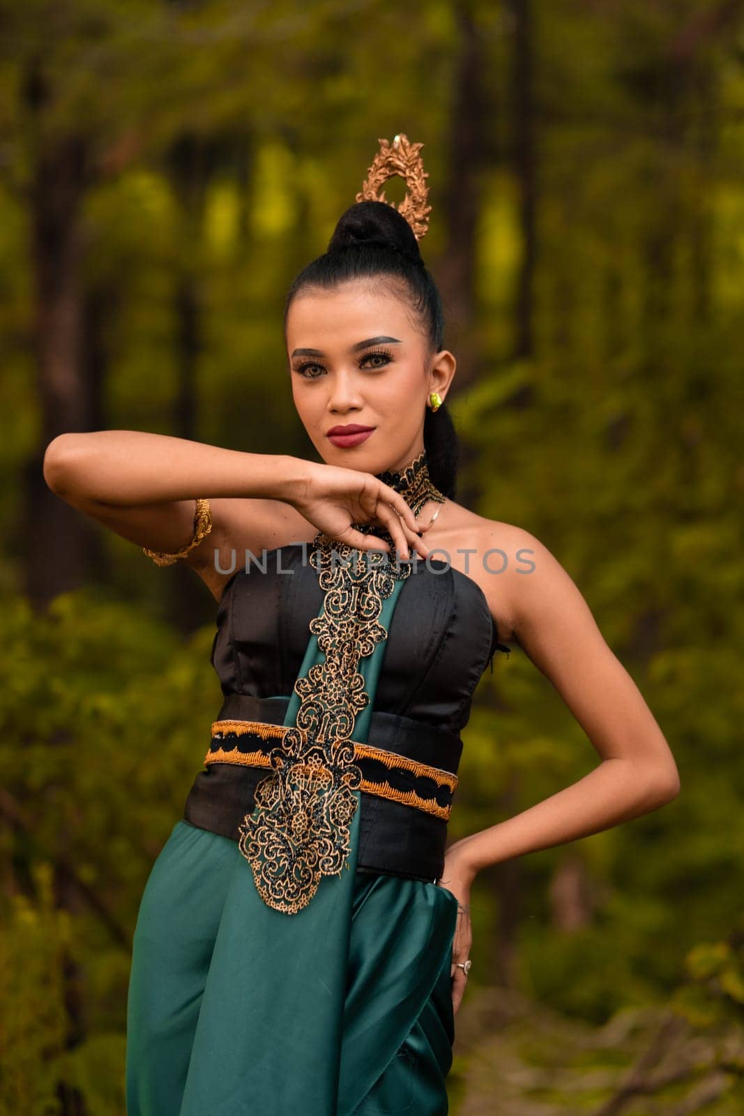 The fierce face of an Indonesian woman wearing makeup on her face and a black costume after a dance performance at the festival