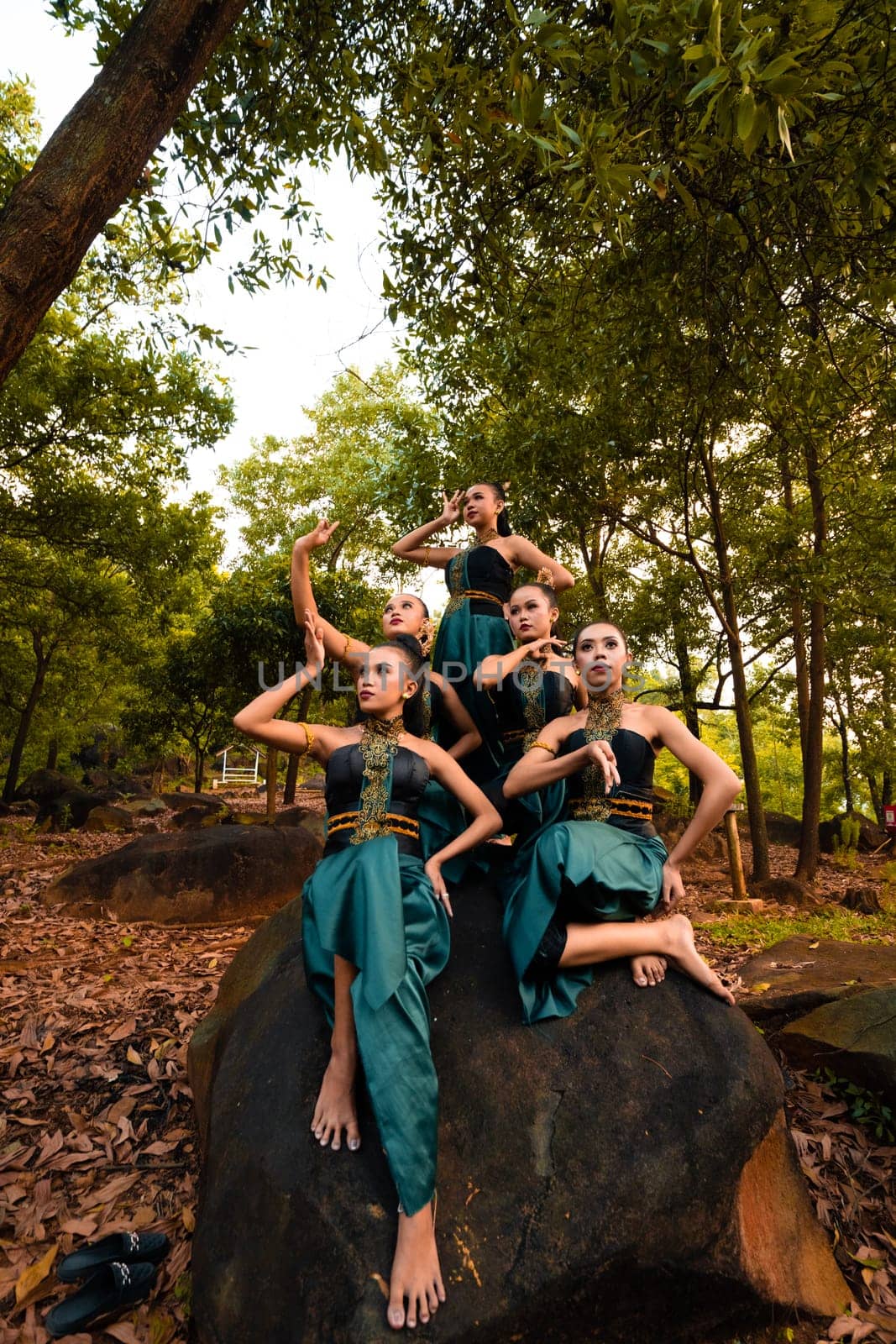 A Group of Balinese people wearing traditional green costume before the dance festival begin in the village