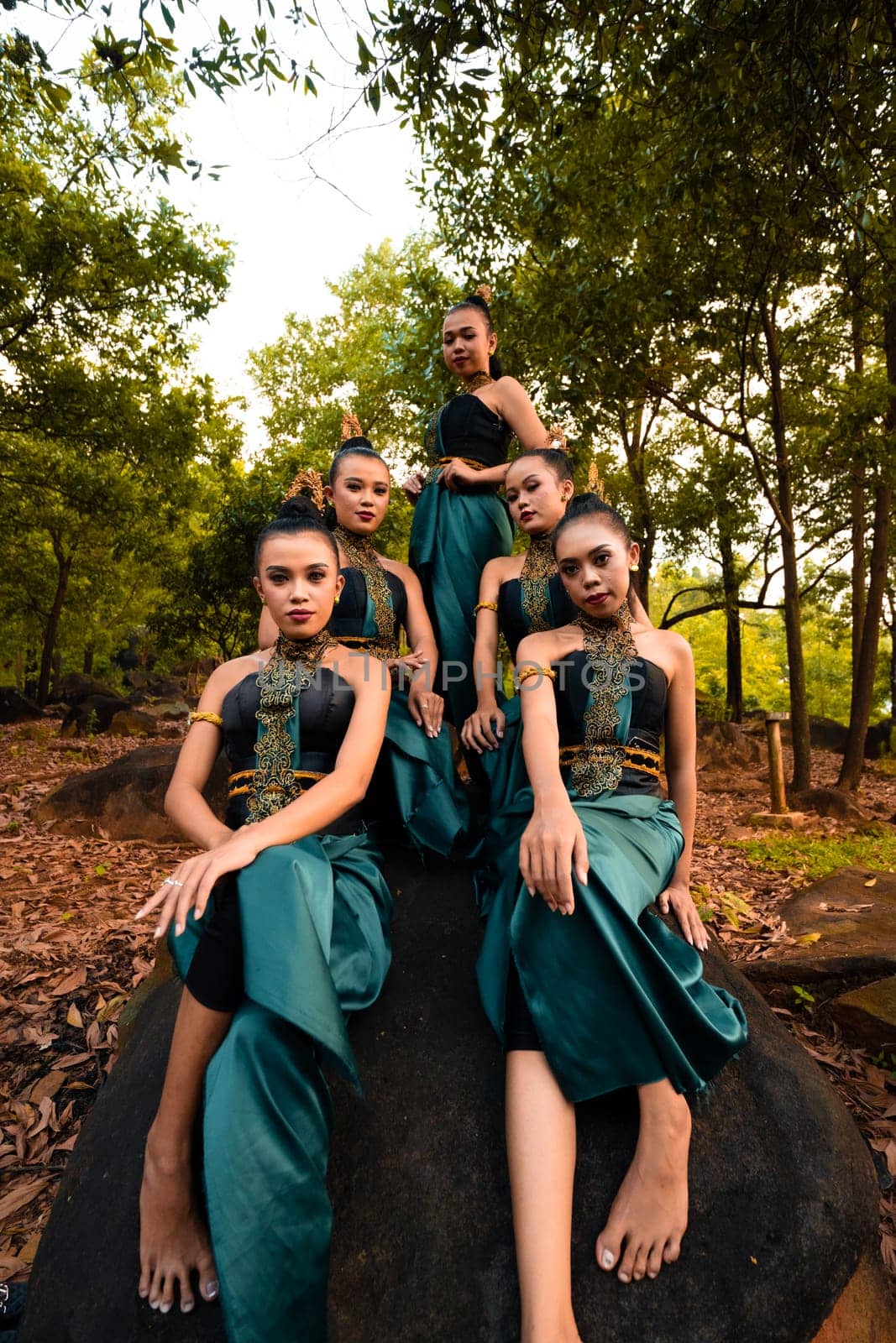 A Group of Balinese people wearing traditional green costume before the dance festival begin in the village