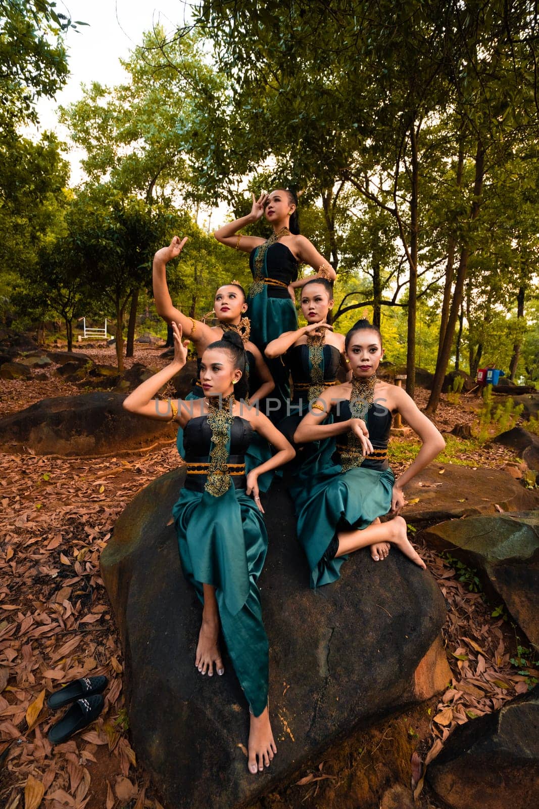 A Group of Balinese people wearing traditional green costume before the dance festival begin in the village