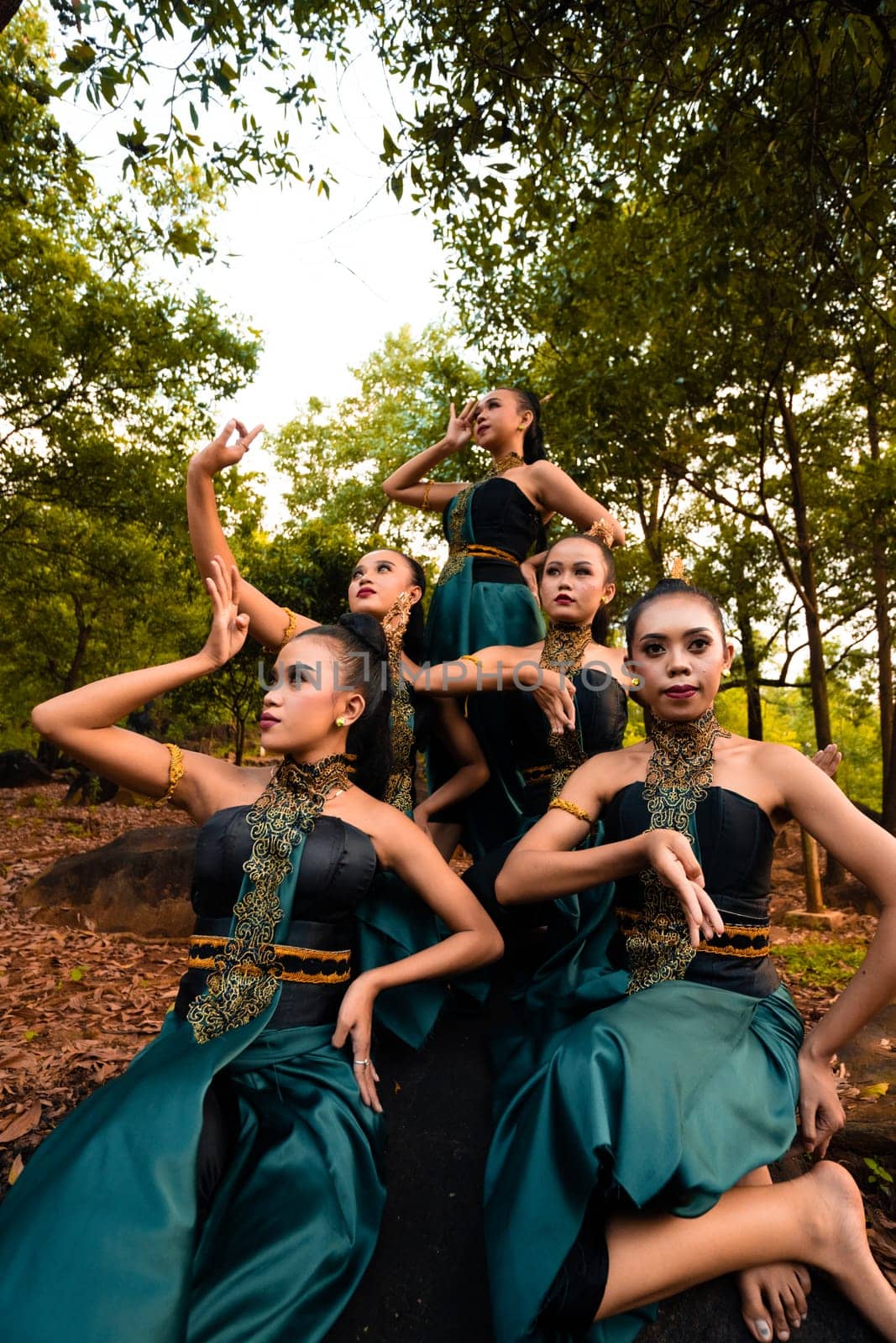 A Group of Balinese people wearing traditional green costume before the dance festival begin in the village