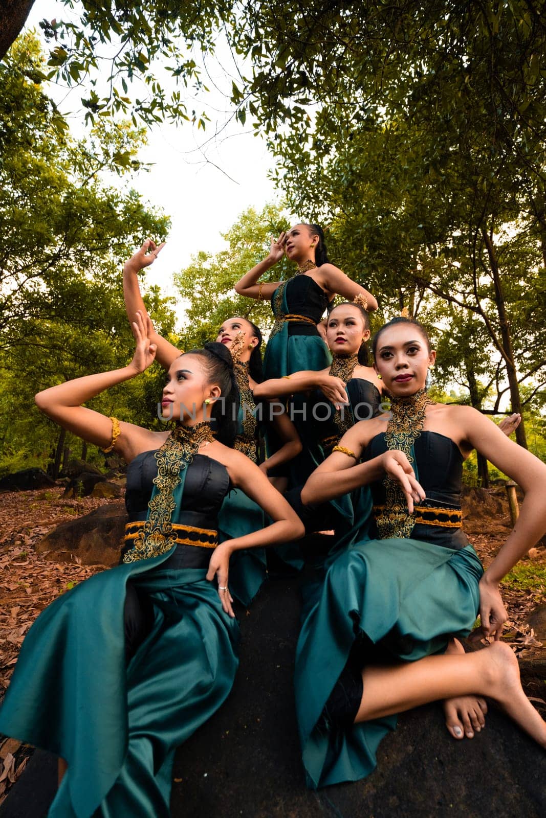 A Group of Balinese people wearing traditional green costume before the dance festival begin in the village
