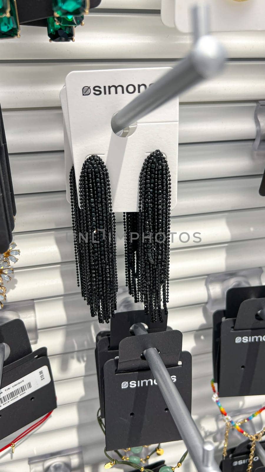 Ottawa, ON Canada - May 11, 2025: Elegant black beaded earrings are showcased on a white card featuring Simon's branding, highlighting intricate craftsmanship and stylish design in a retail environment