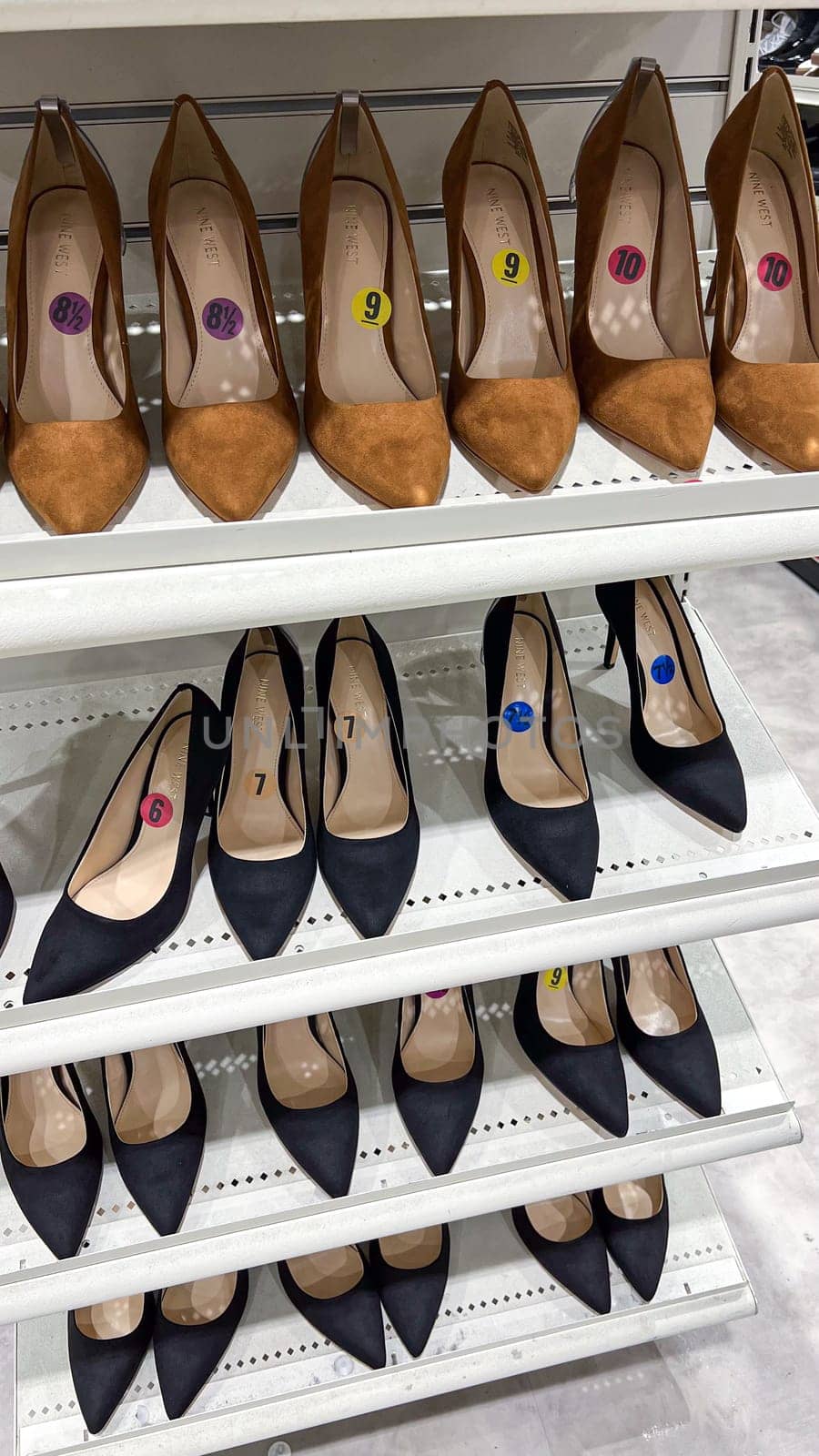 Ottawa, Canada - March 02, 2025: A collection of stylish high-heeled shoes arranged on a retail shelf, showcasing a variety of colors and sizes, perfect for fashion women looking for elegant footwear