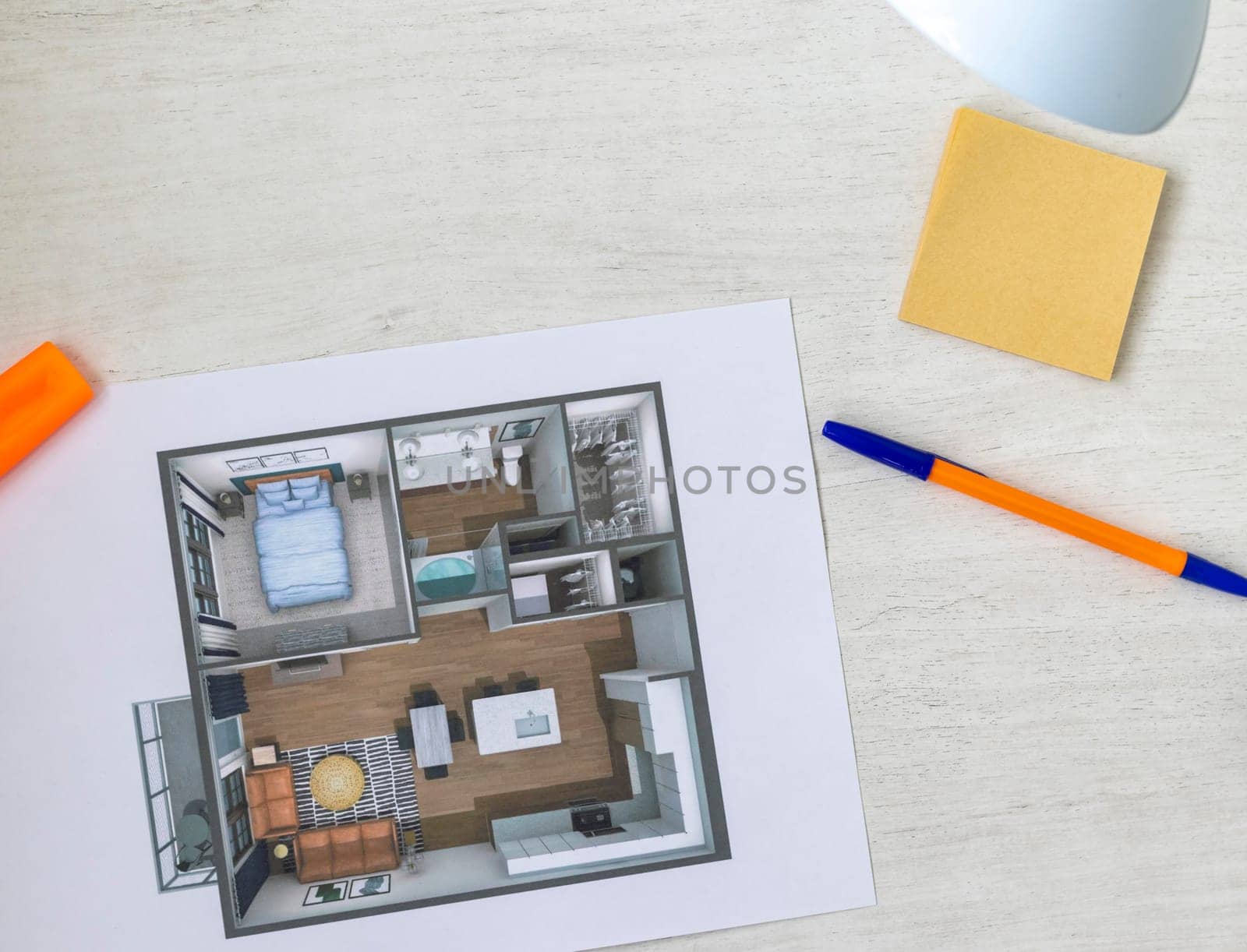 Layout of the small, furnished apartment printed on the sheet of paper placed on the desk
