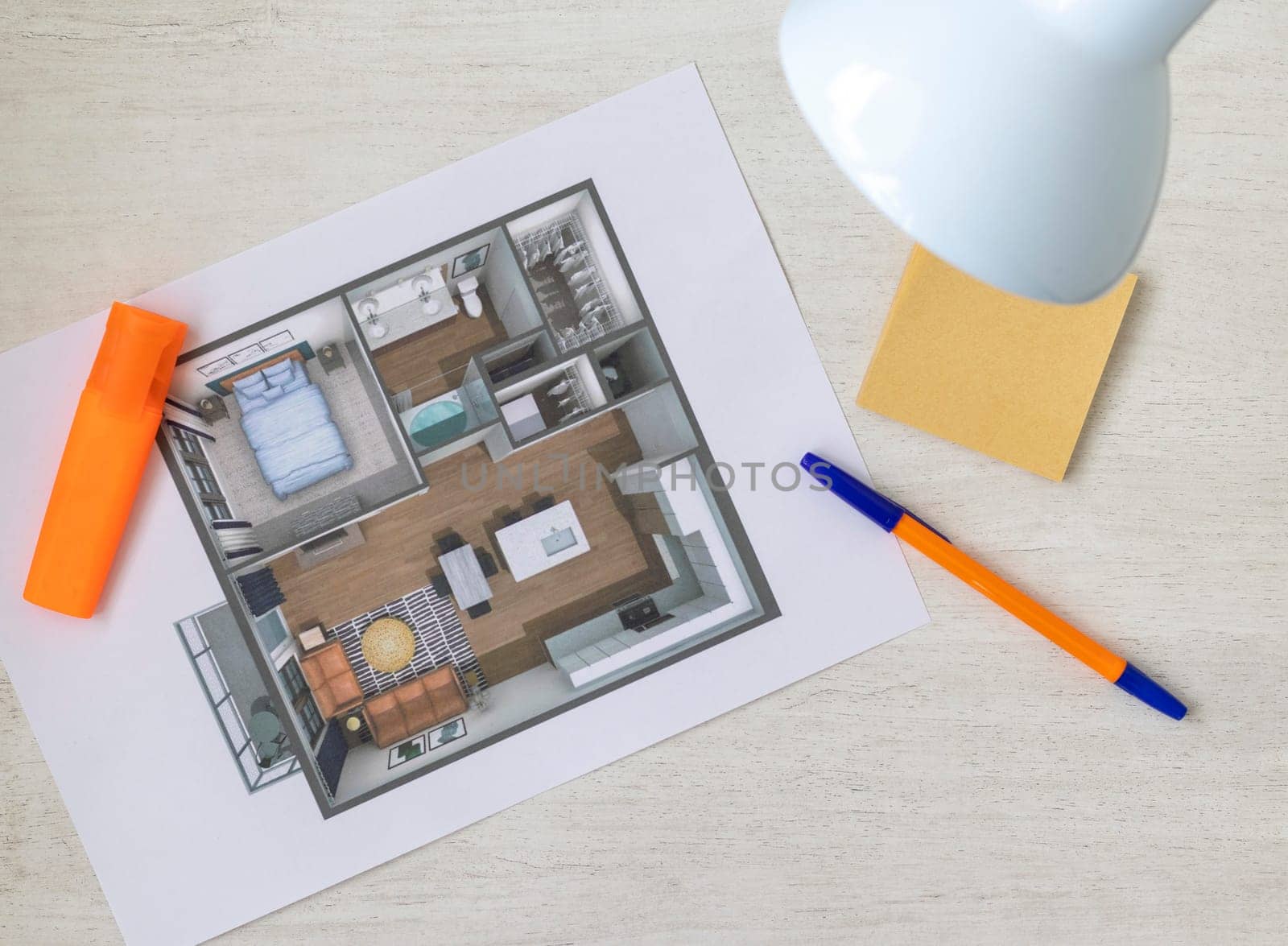 Layout of the small, furnished apartment printed on the sheet of paper placed on the desk