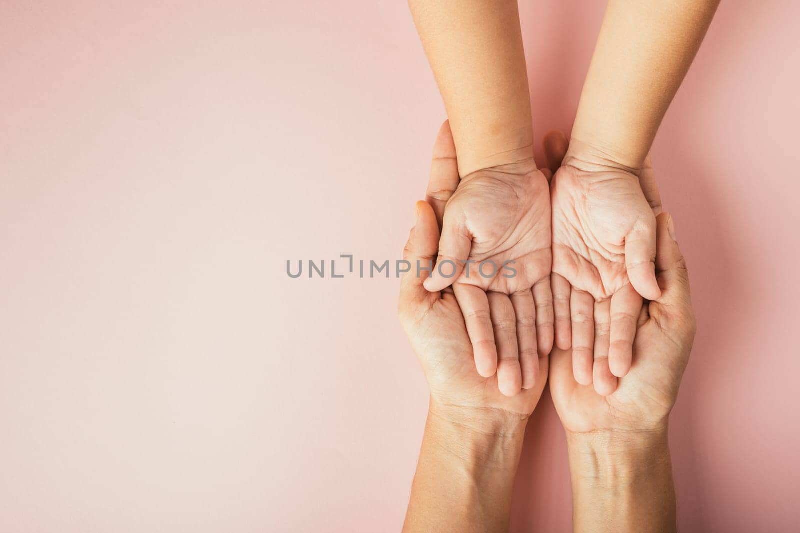 Family day concept, Top view of parents and kid holding empty hands isolated on a color background. Celebrating togetherness and support.