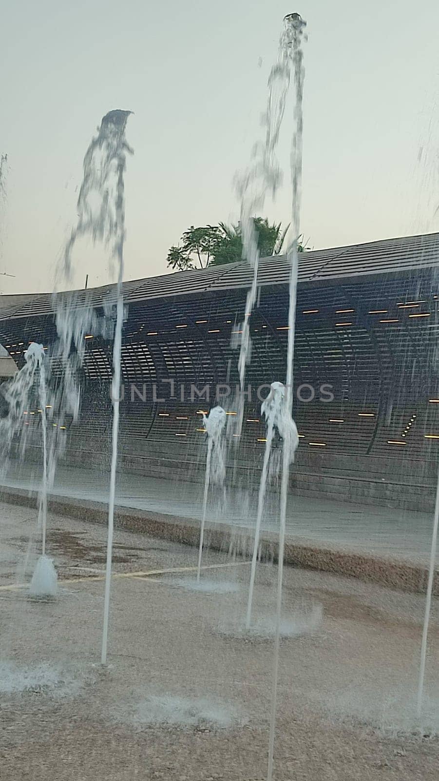 Water fountains splashing street building architecture travel shotlisttravel place destination objects city centre town trees green nature park summer tree vertical place destination objects . High quality photo