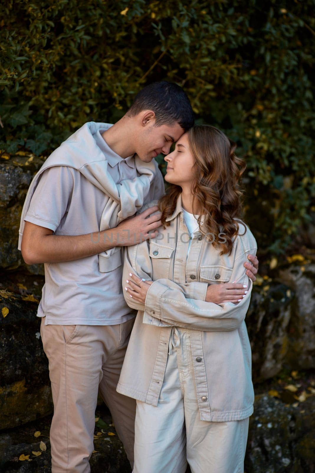 Young Cute Female Hugs Boyfriend. In Autumn Outdoor. Lovers Walking in Park. Attractive Funny Couple. Lovestory in Forest. Man and Woman. Cute Lovers in the Park. Family Concept. Happy Couple.