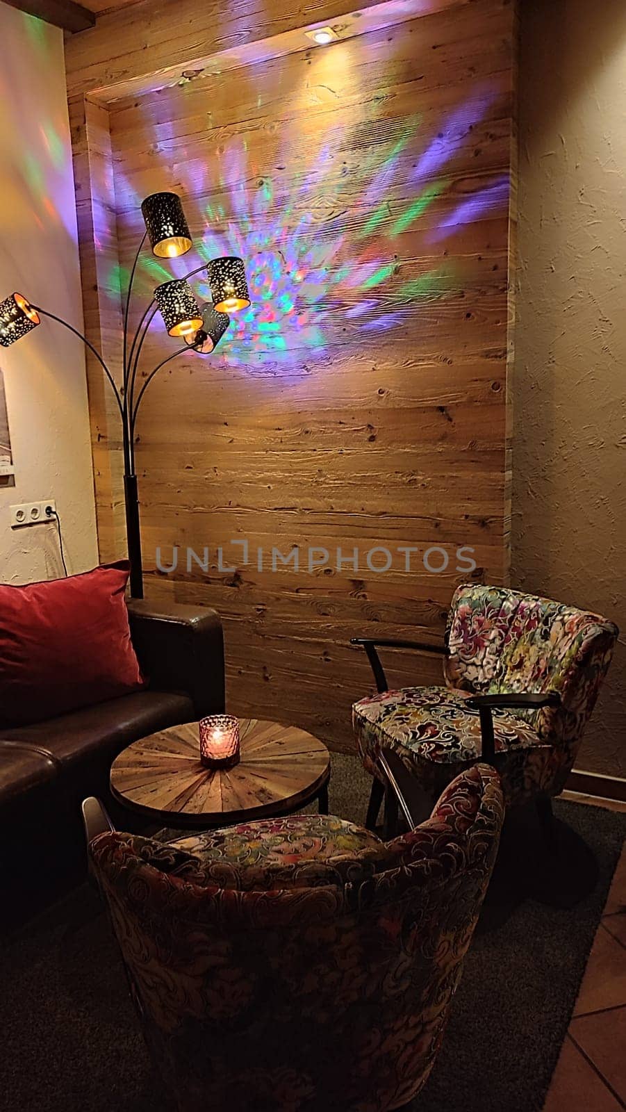 Cozy colorful corner table restaurant objects chear sits night light evening furniture objects building architecture design decor decorations indoor house interior lights lamp . High quality photo