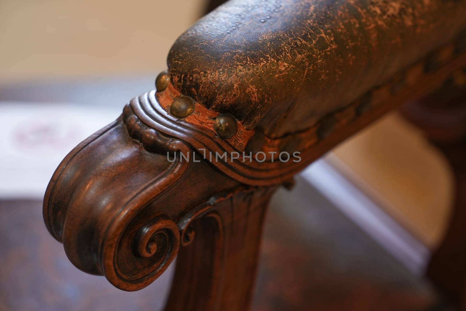 A wooden antique leather carved armchair
