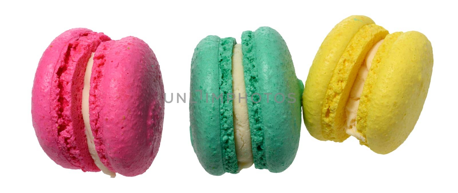 Three multicolored macarons with white filling on isolated background