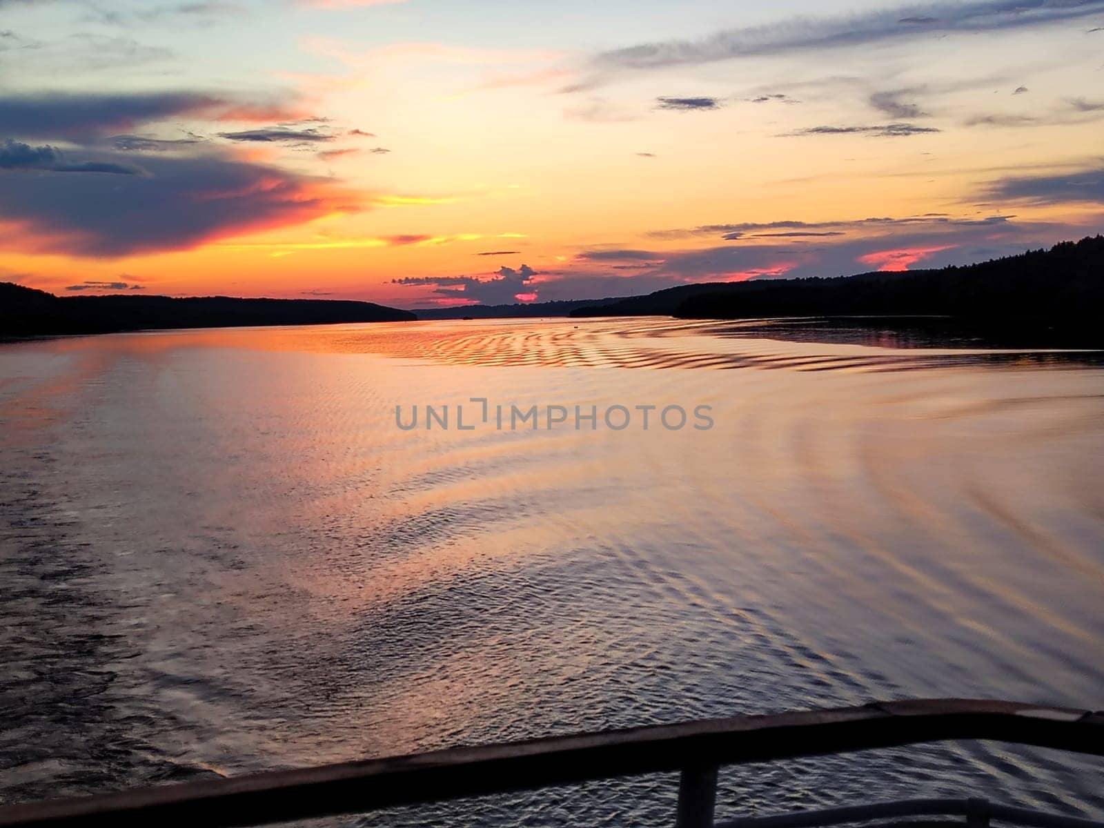Sunset view and water mark during a tourist cruise, romantic evening.