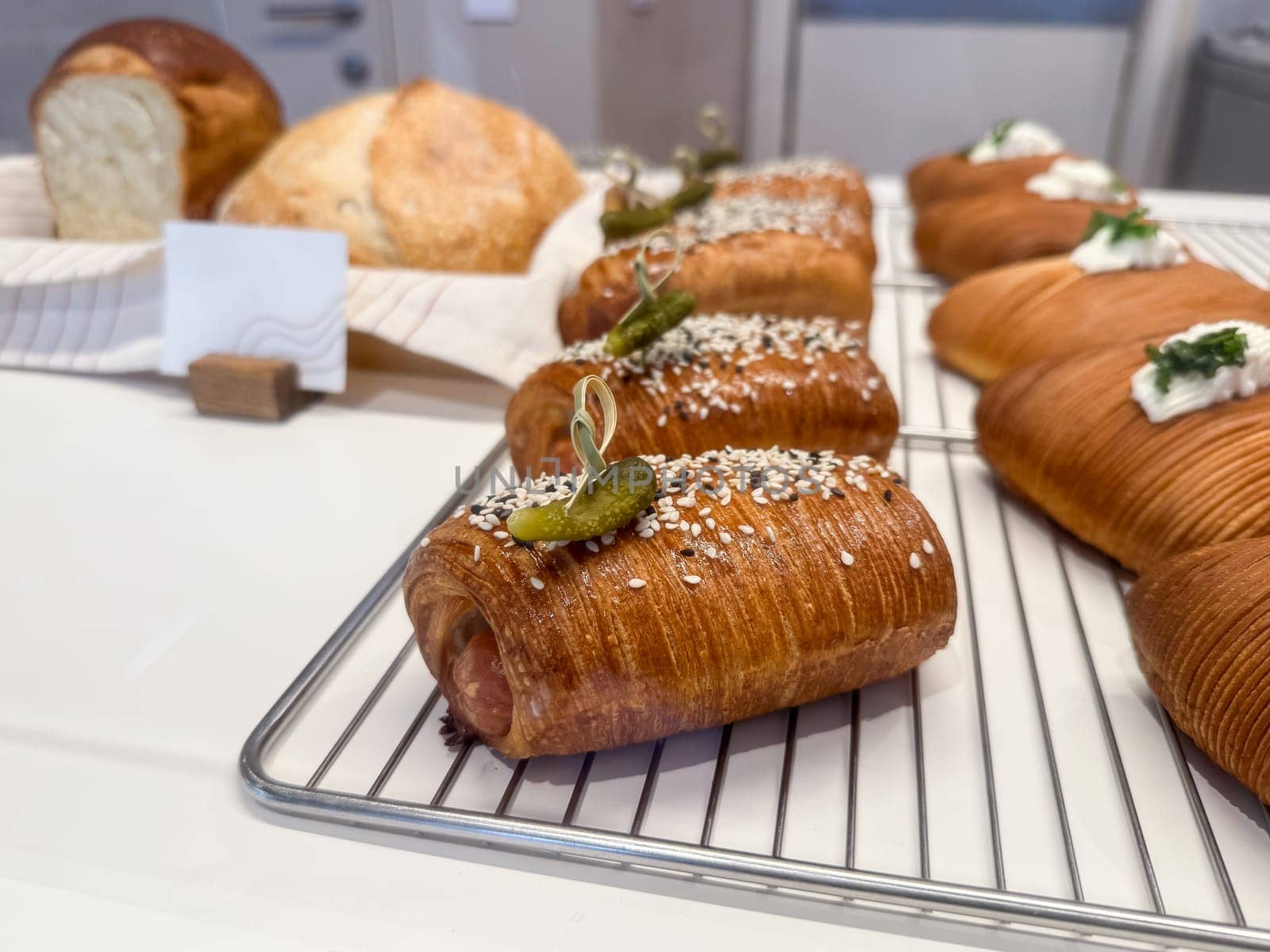Artisan croissants with sesame and pickle. Modern fusion bakery and creative snack design.