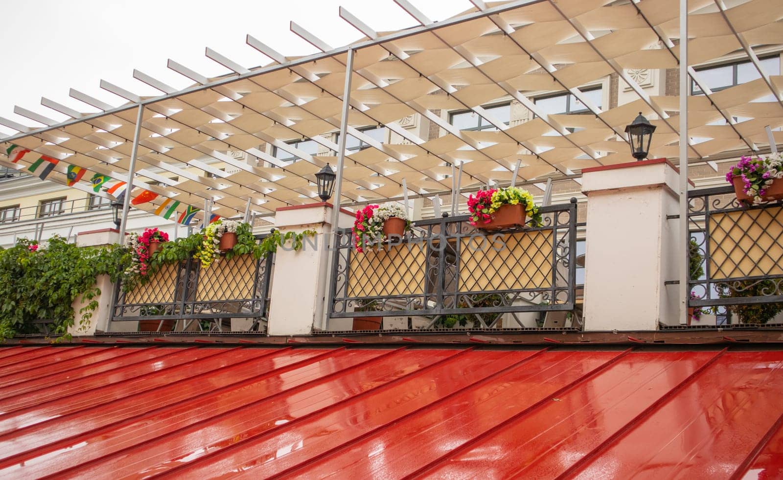 Exterior exterior of outdoor patio with metal lattice and flower boxes, country flags.