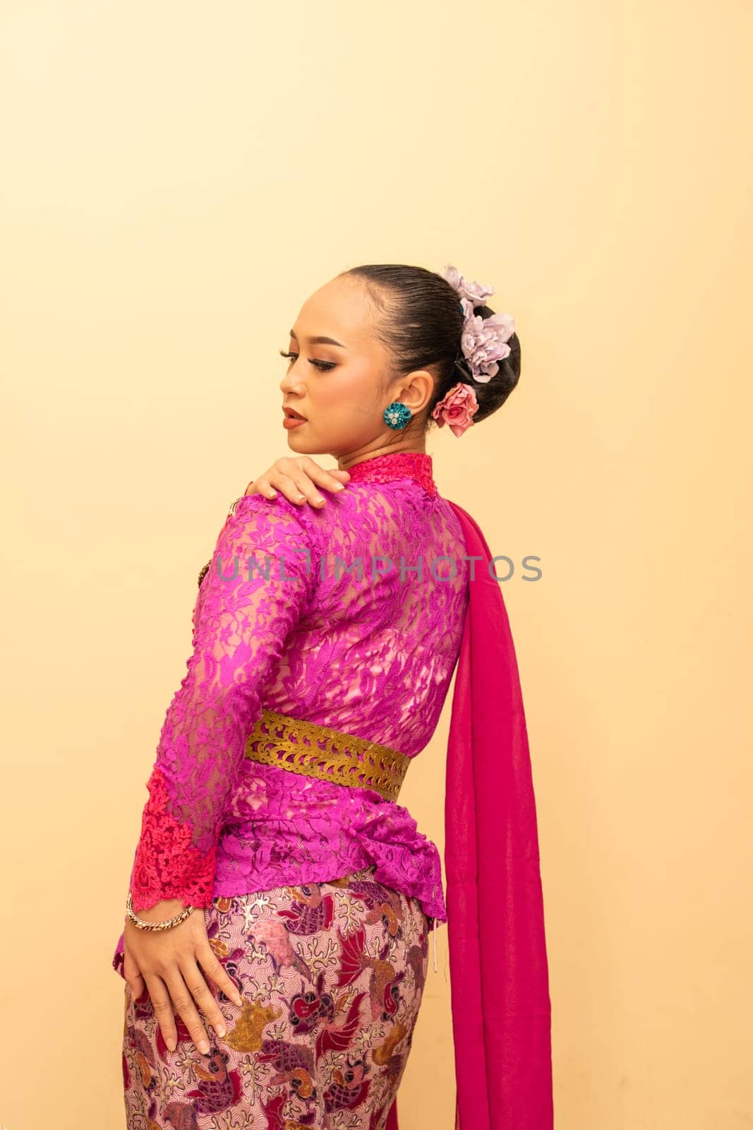 Javanese woman wearing traditional pink dress called kebaya on the Indonesian independence day